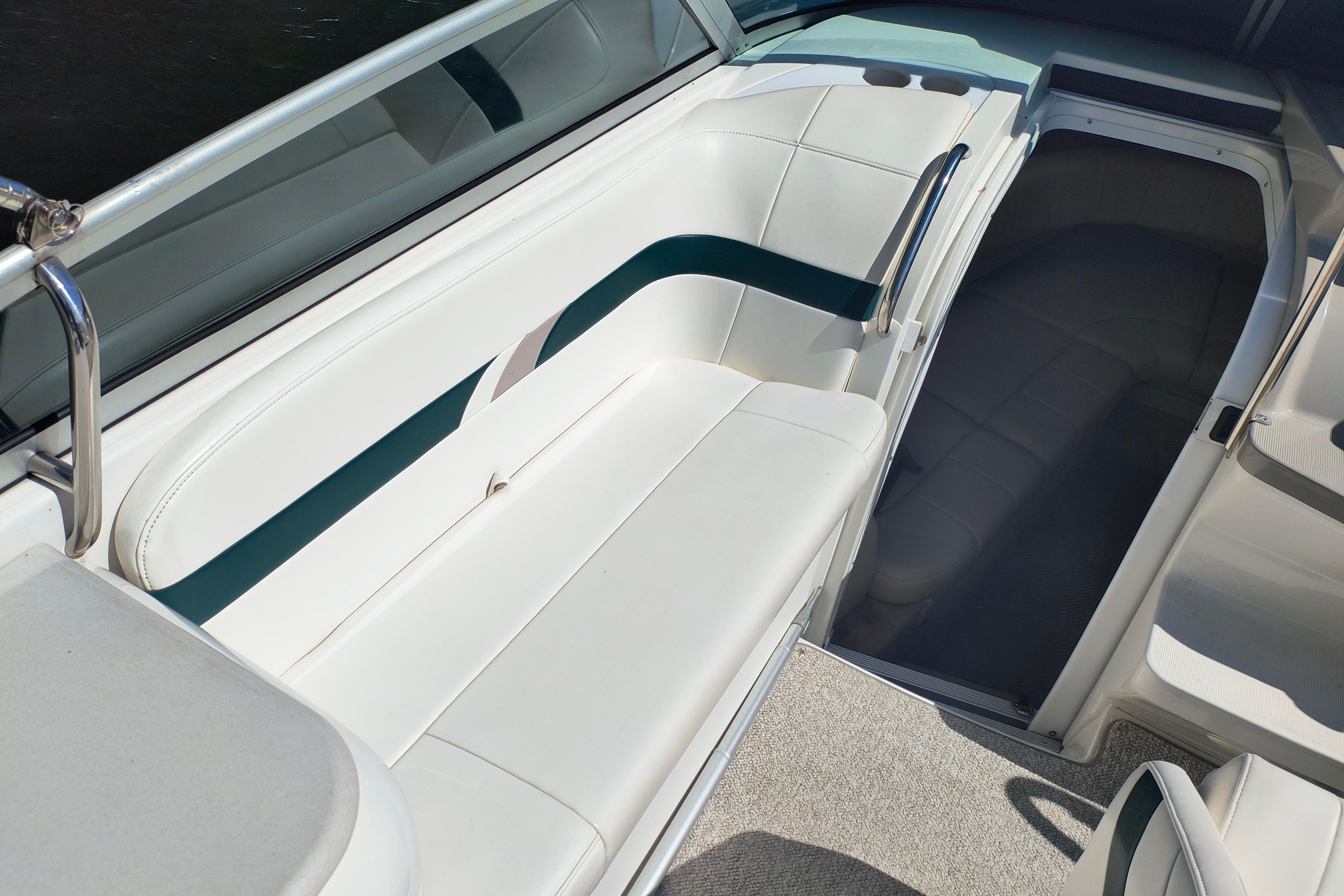 2003 Formula 260 Sun Sport boat interior with white seating and teal accents.