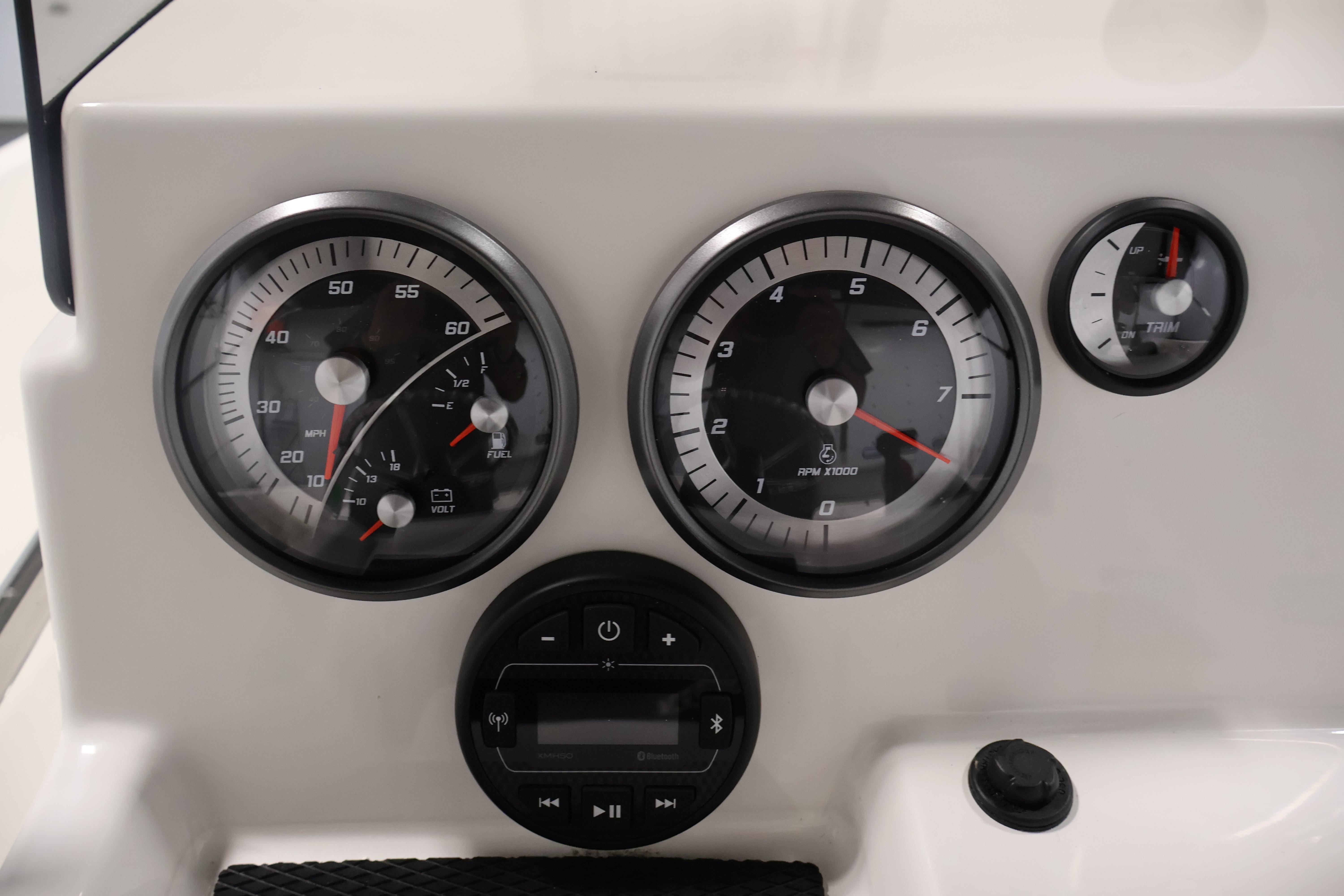 Dashboard of 2026 Bayliner Trophy T18 boat with speedometer, tachometer, and trim gauge.