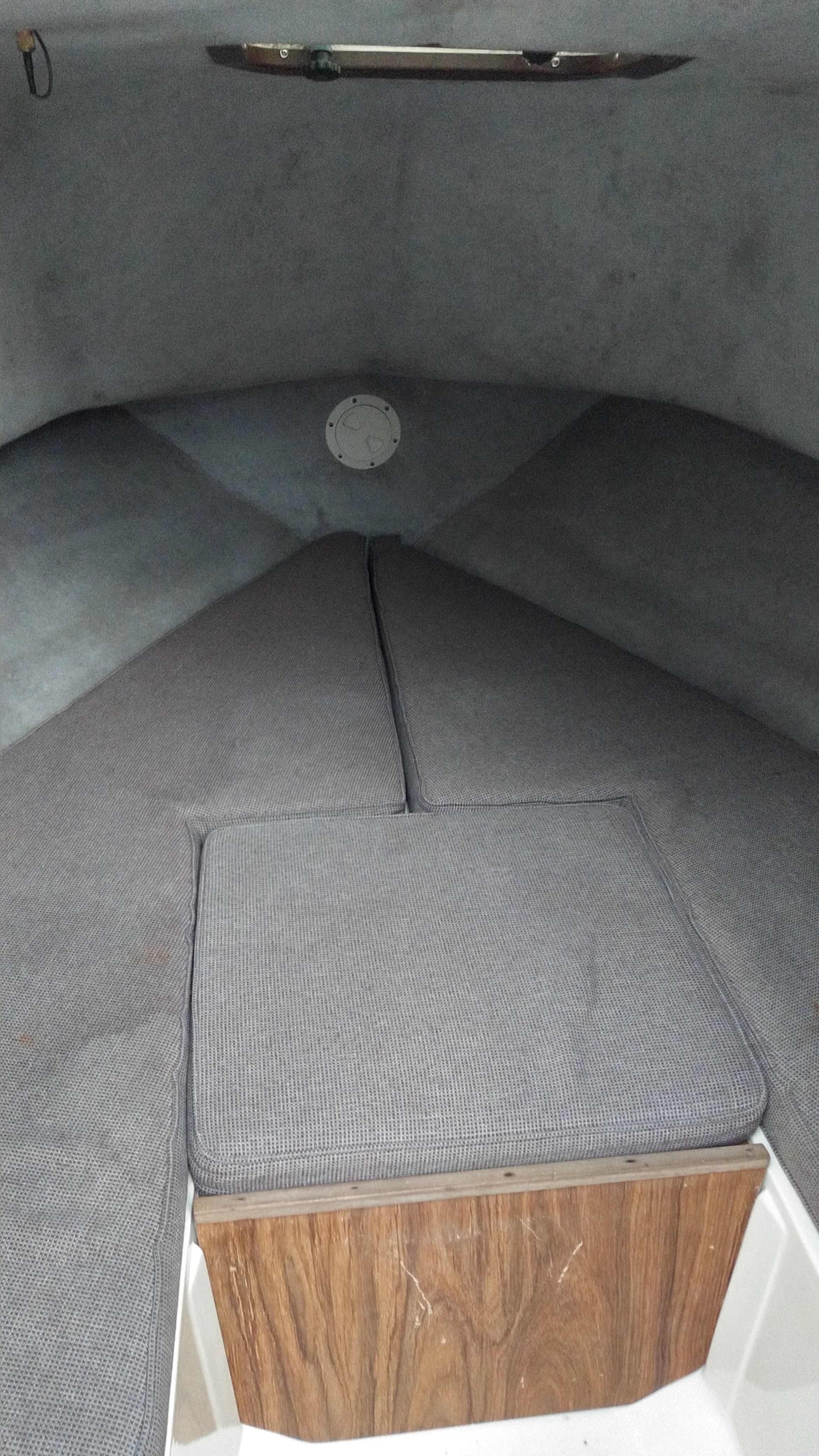 Interior of a 1989 Mako 240 Walk Around with gray upholstery.