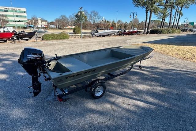2026 Tracker Grizzly 1648 Utility boat on trailer, parked outdoors with Mercury outboard motor.