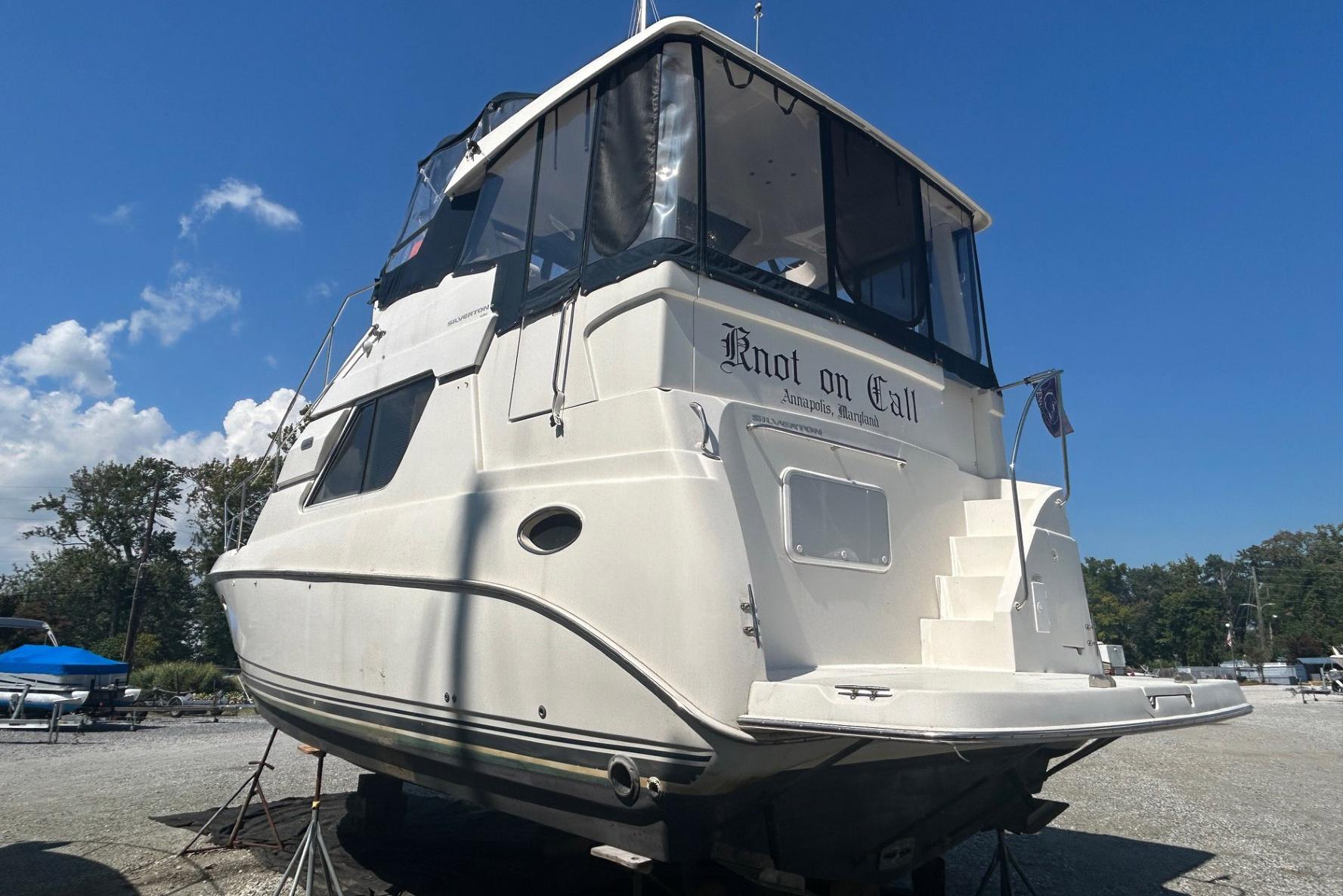 2000 Silverton 352 Motor Yacht "Knot on Call" docked under clear blue sky.