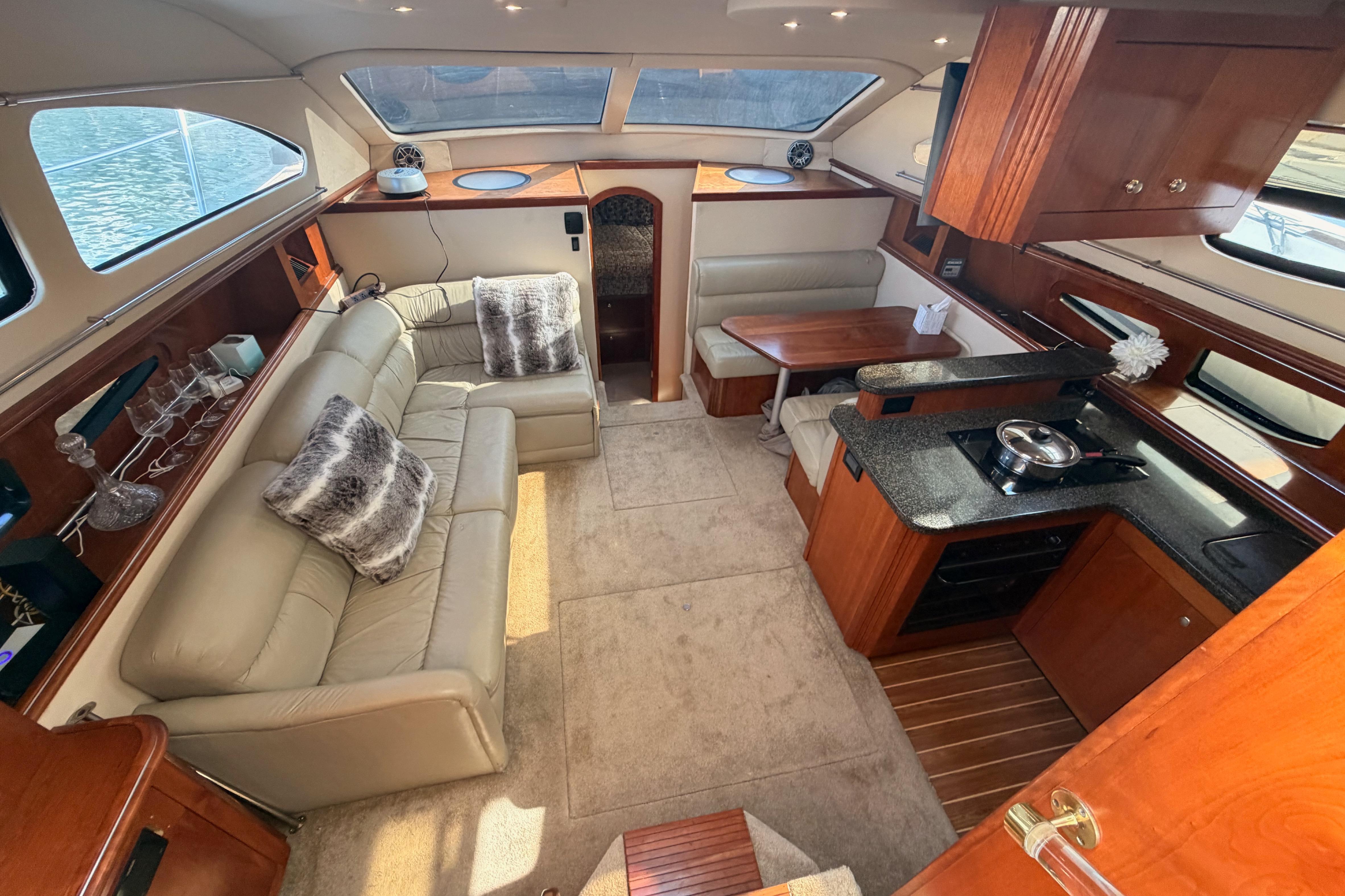 Luxurious 2005 Cruisers Yachts 405 Express Motoryacht interior with plush seating and modern kitchen.