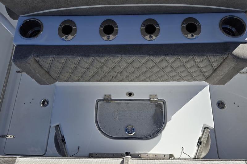 2026 Sea Hunt Ultra 275 Coffin Box interior with rod holders and storage compartment.