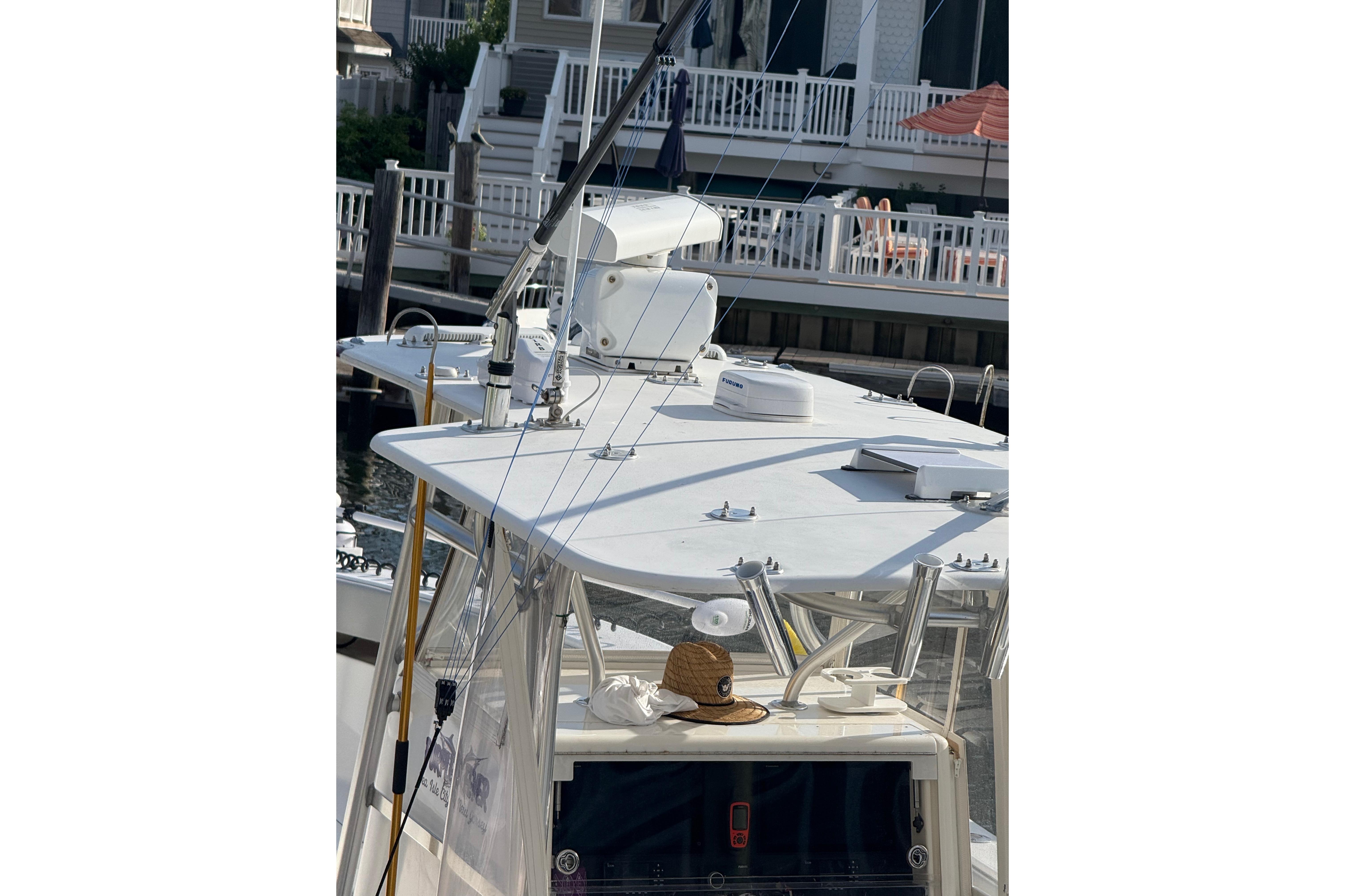 2006 SeaVee 340B boat docked, featuring a spacious deck and fishing equipment.
