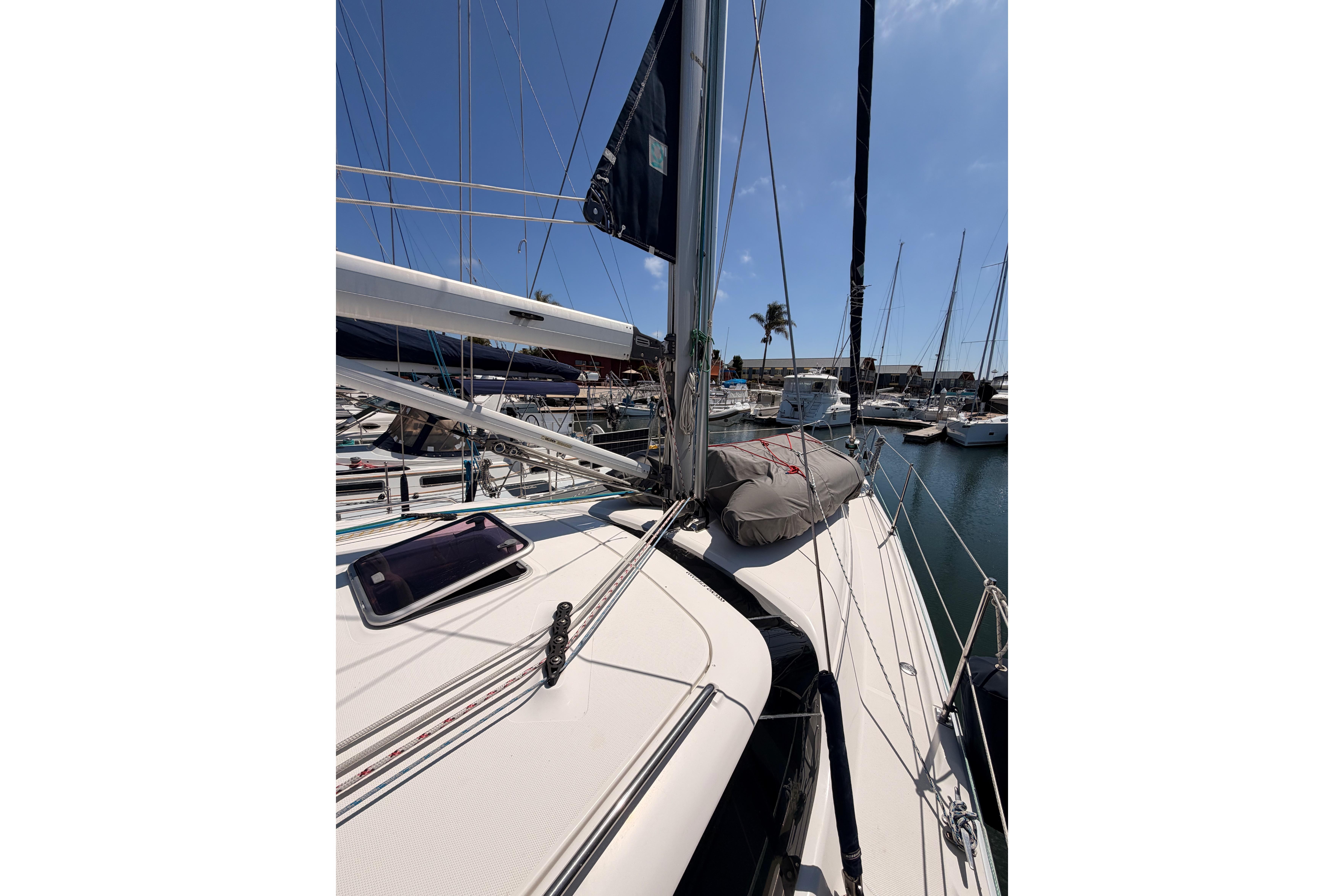 2008 Hunter 45 Deck Salon sailboat docked in marina under clear blue sky.