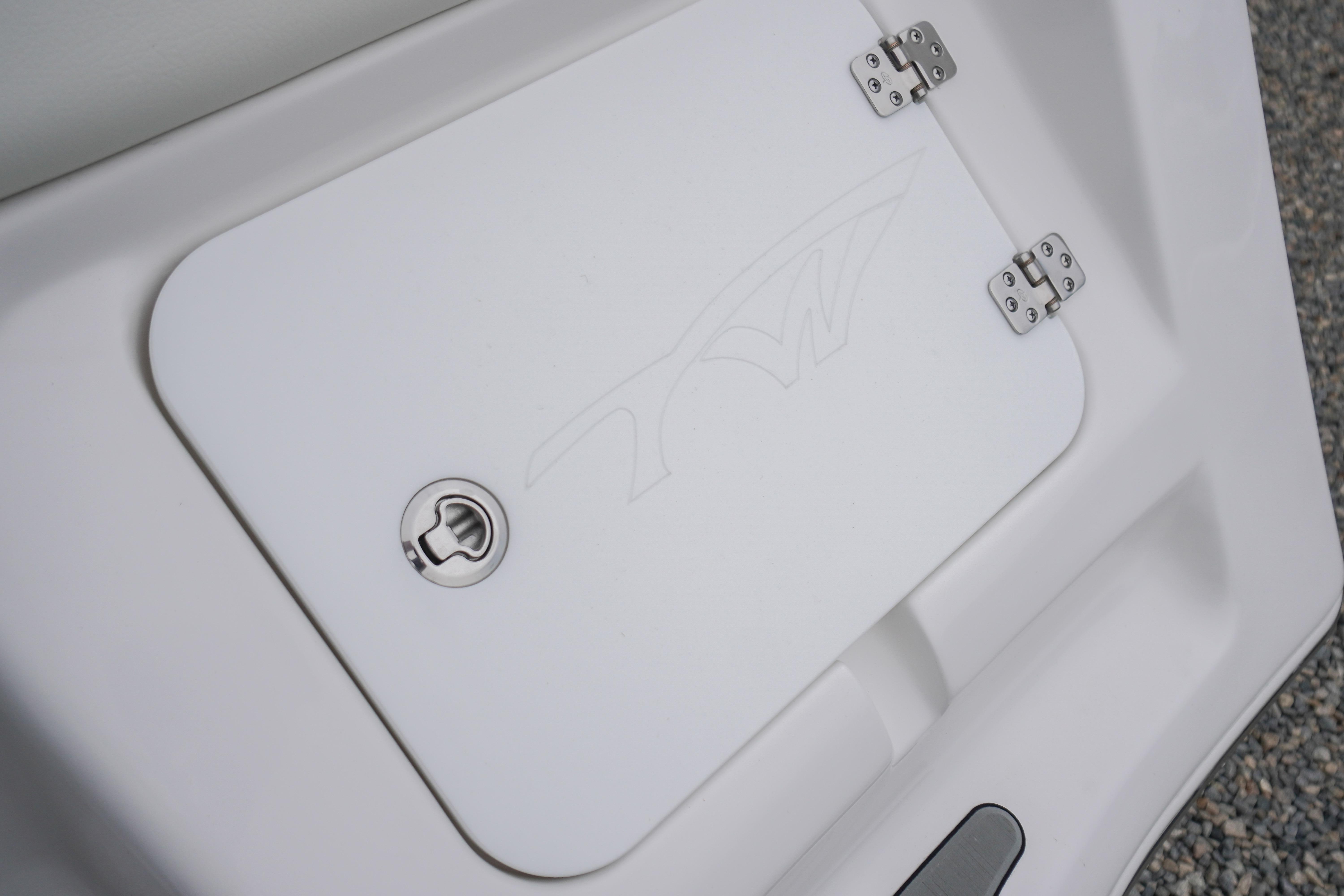 2026 Tidewater 232 SS boat compartment with secure latch and hinges.