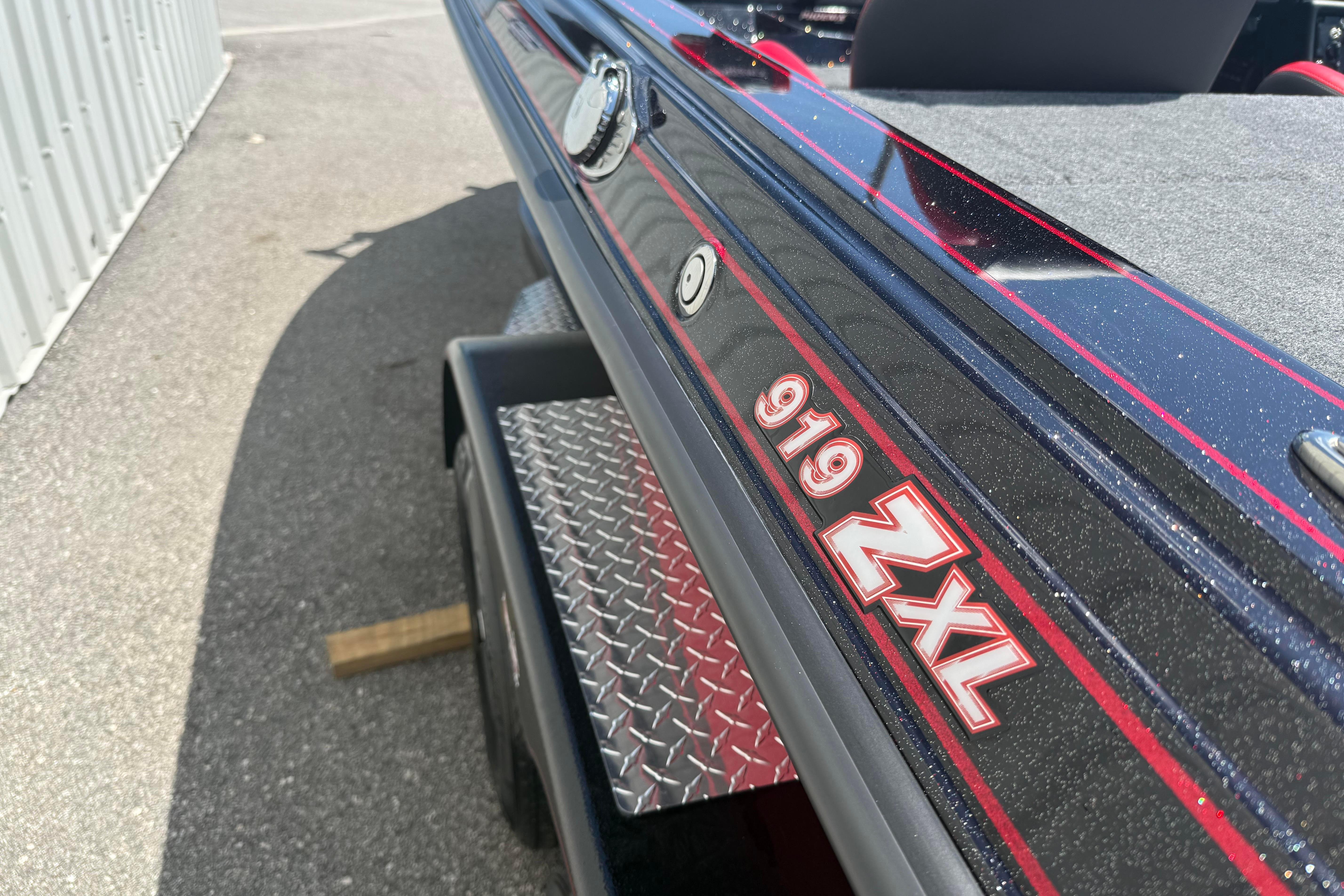 2027 Phoenix 919 ZXL boat on trailer, featuring sleek black and red design.