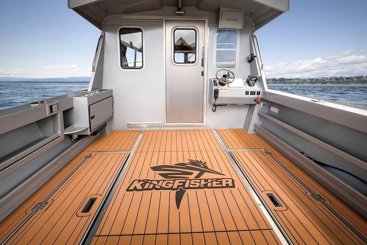 2026 KingFisher 3225 GFX Offshore boat interior with wood flooring and steering console.