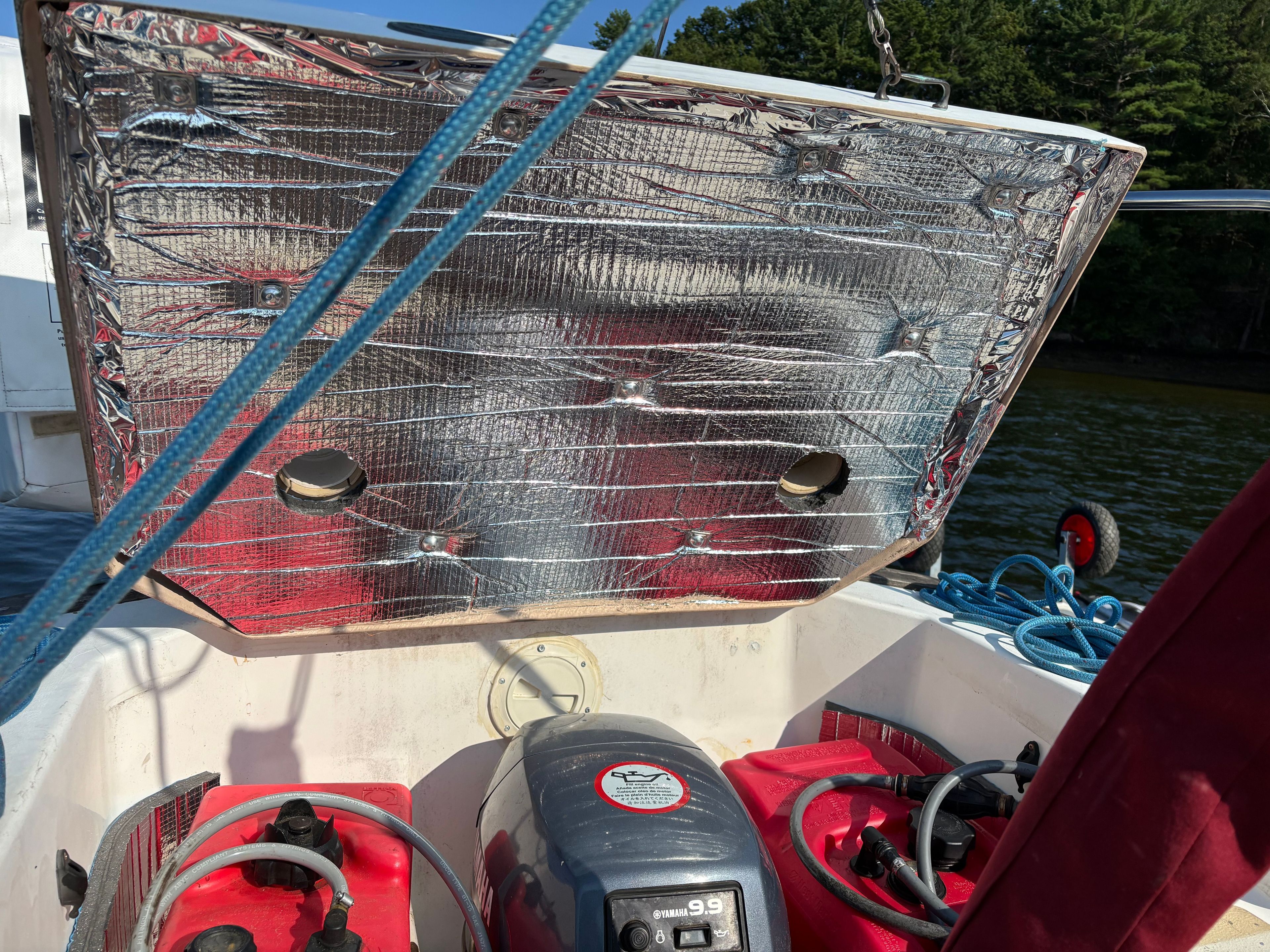 Cape Dory 26 boat with reflective cover and motor, year 1986.