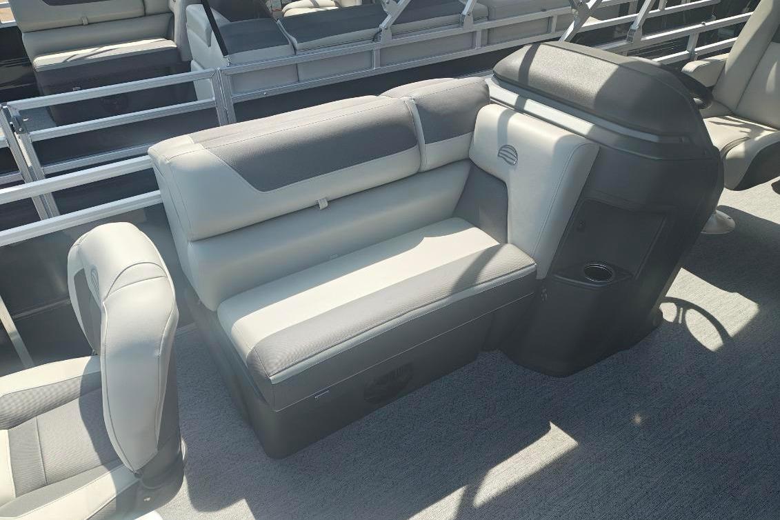 2026 Sun Tracker Fishin' Barge 20 DLX interior with gray seating and console.