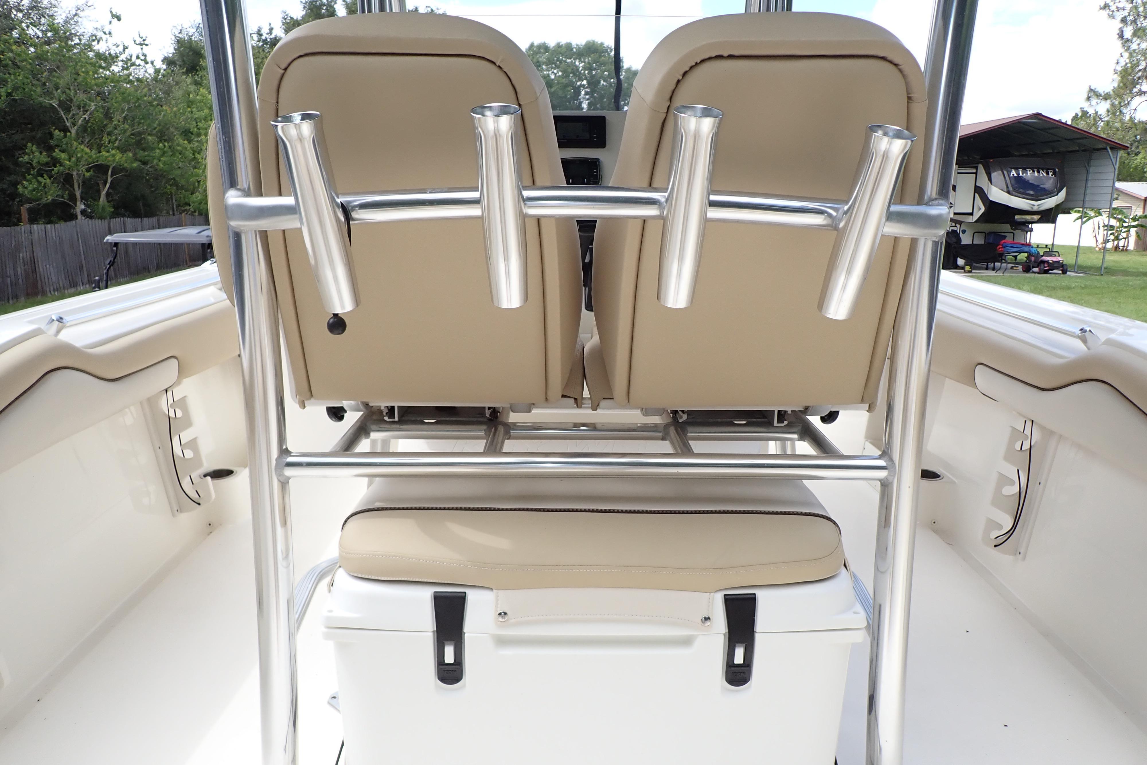 2019 Key West 263 FS boat interior with beige seating and rod holders.