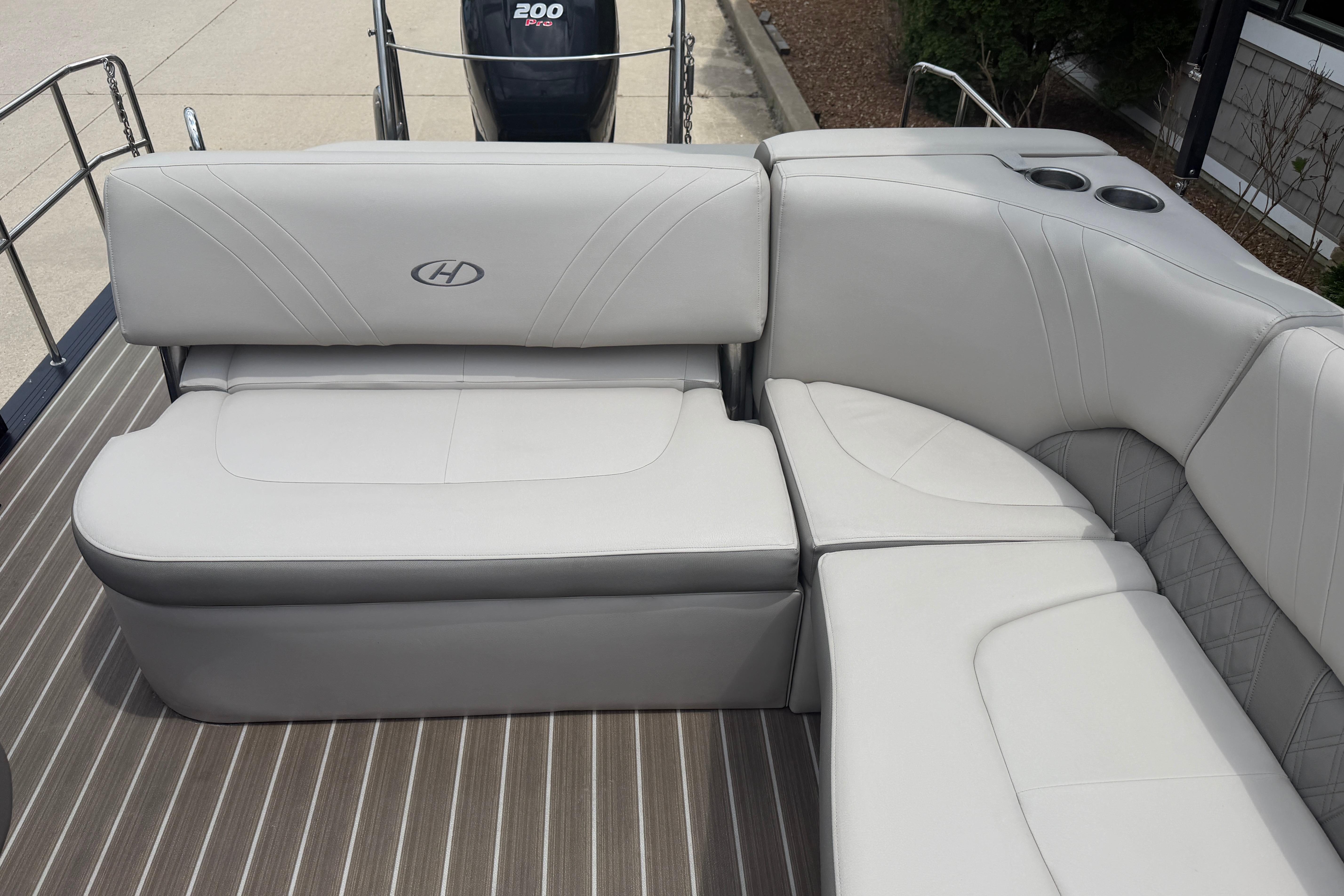 2019 Harris Solstice 240 boat interior with plush seating and cup holders.