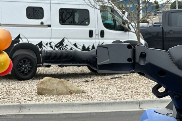 Close-up of a Yamaha WaveRunner JETBLASTER-BLACK handlebar, parked outdoors.