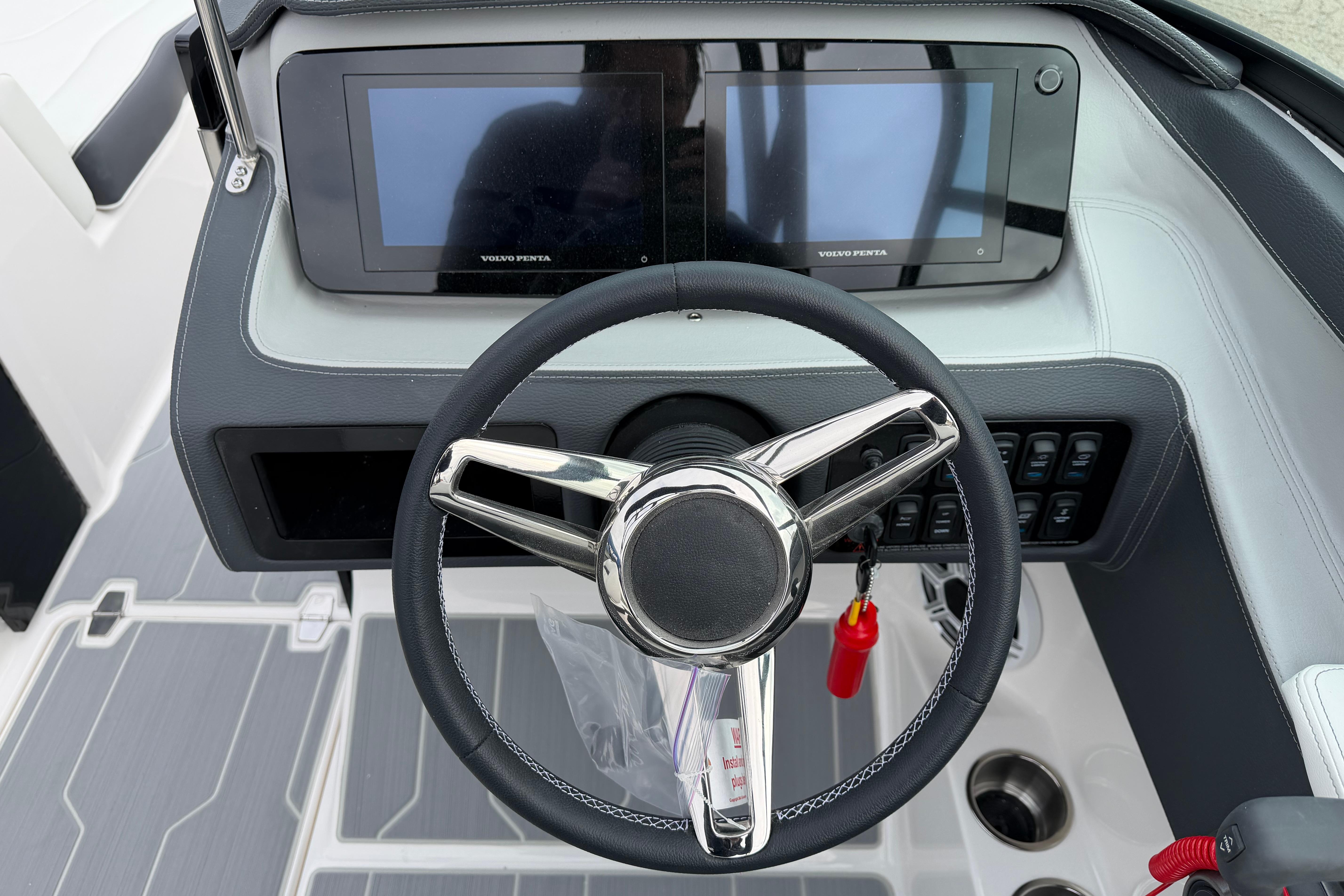 Steering wheel and dashboard of 2026 Regal LS2 Surf boat with dual displays.