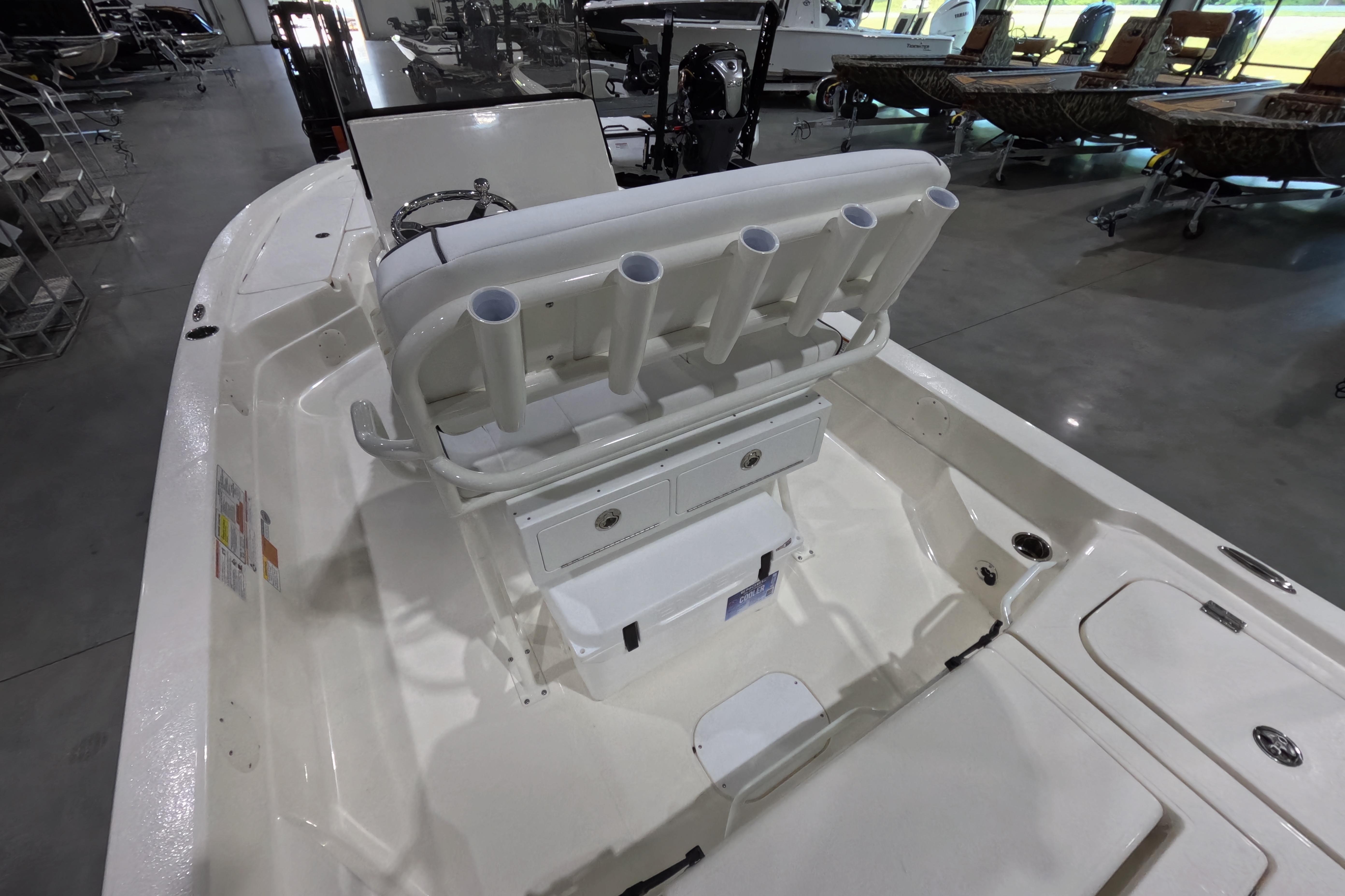 2026 Skeeter boat interior with rod holders and storage compartments in a showroom.