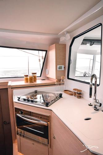 Modern kitchen interior of 2025 Nautitech 40 Open catamaran with sleek design and ocean view.