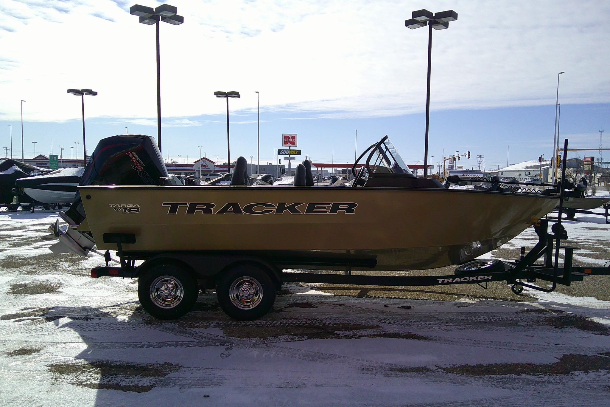 2026 Tracker Targa V-19 Combo boat on trailer in snowy parking lot.