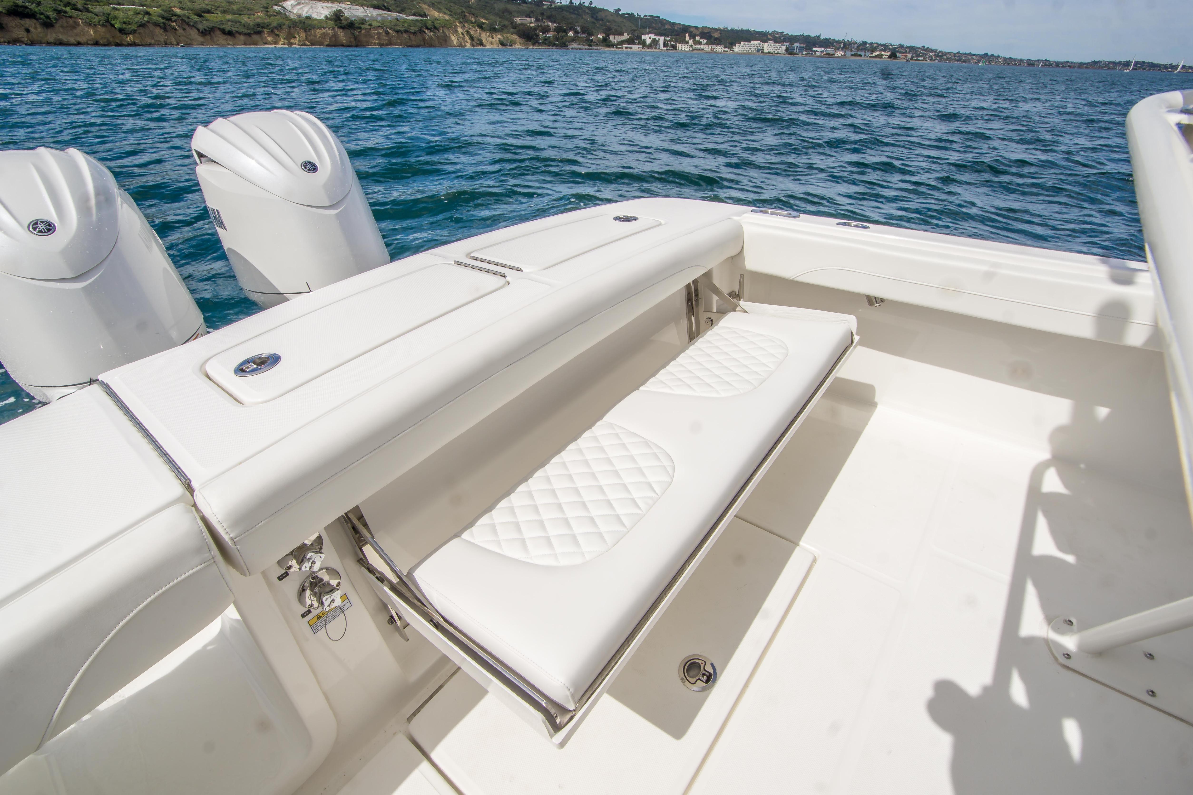 2026 Regulator 23 boat with white seating and dual engines on open water.