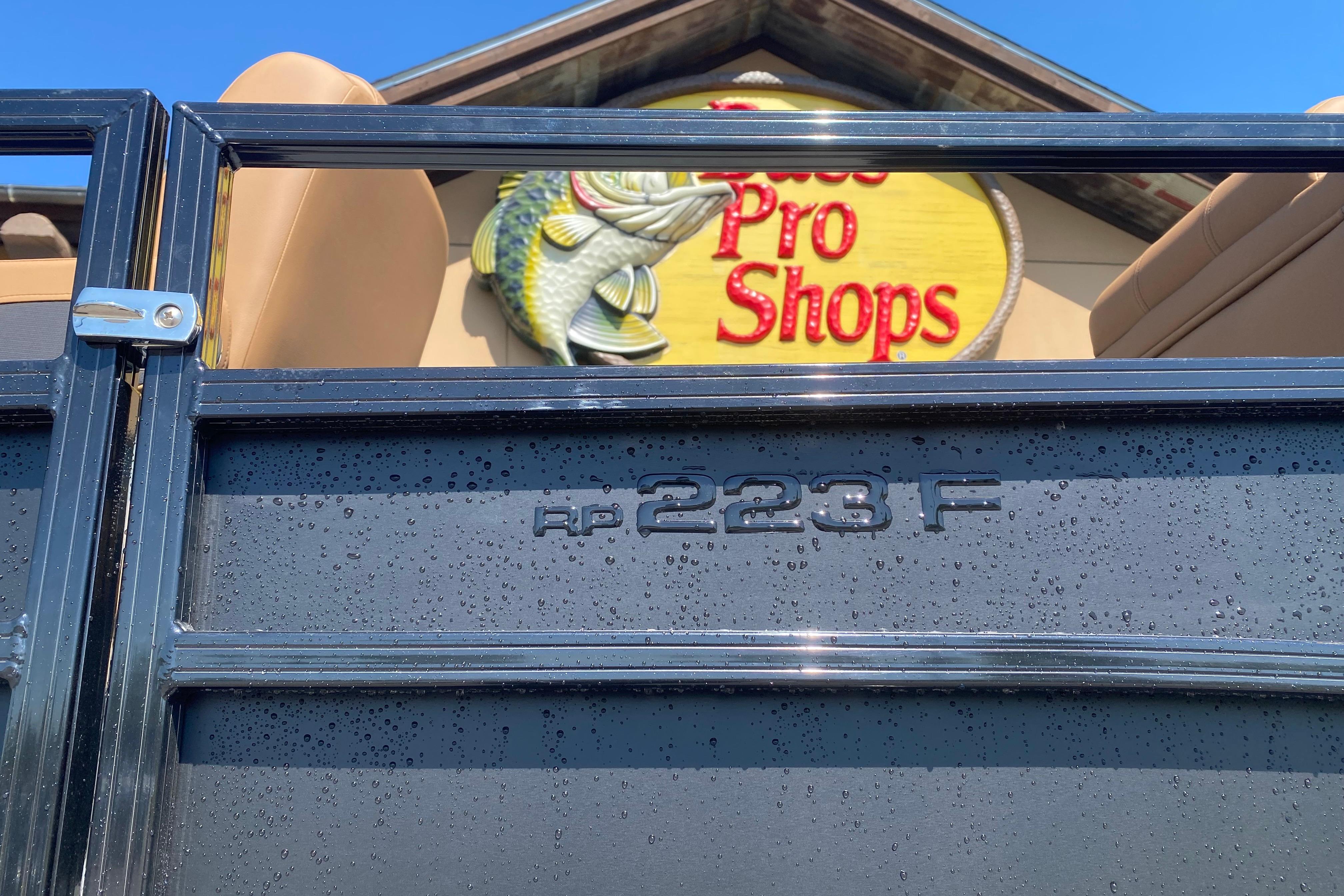 2026 Ranger 223F boat at Bass Pro Shops, featuring sleek design and branding.