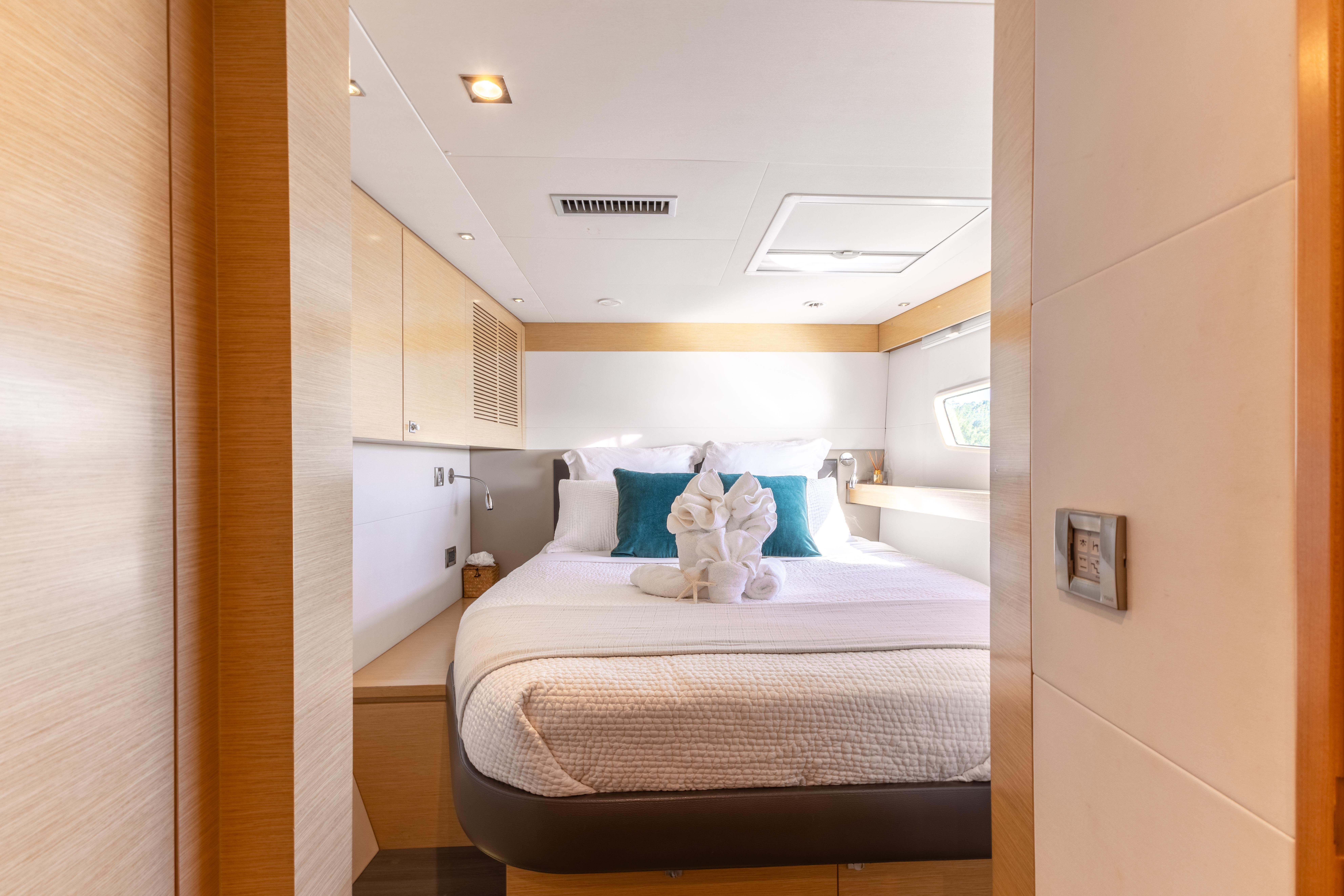 Luxurious bedroom interior of 2017 Fountaine Pajot Victoria 67 yacht with elegant decor.