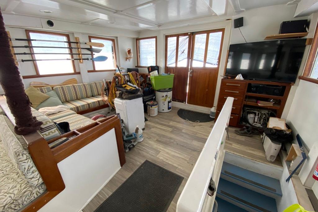 Interior of a 1979 Shrimper Conversion Trawler with cozy seating and fishing gear.