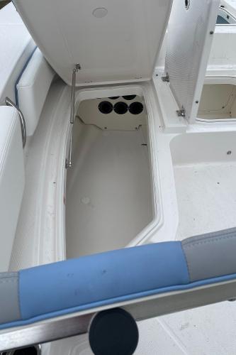 2026 Robalo 246 Cayman boat storage compartment with open hatch and seating area.