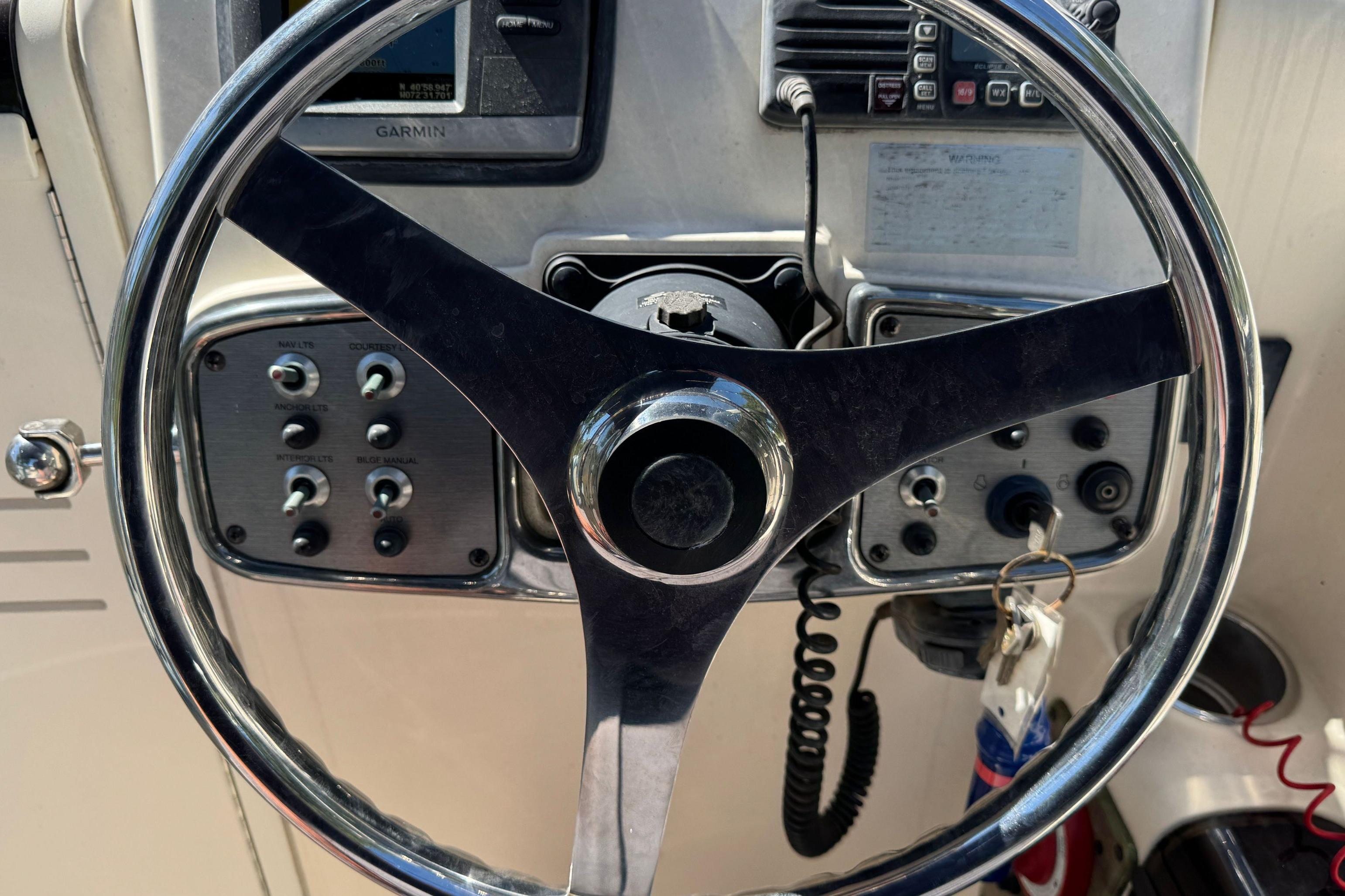 Steering wheel and controls of a 2008 Scout 222 Abaco boat.