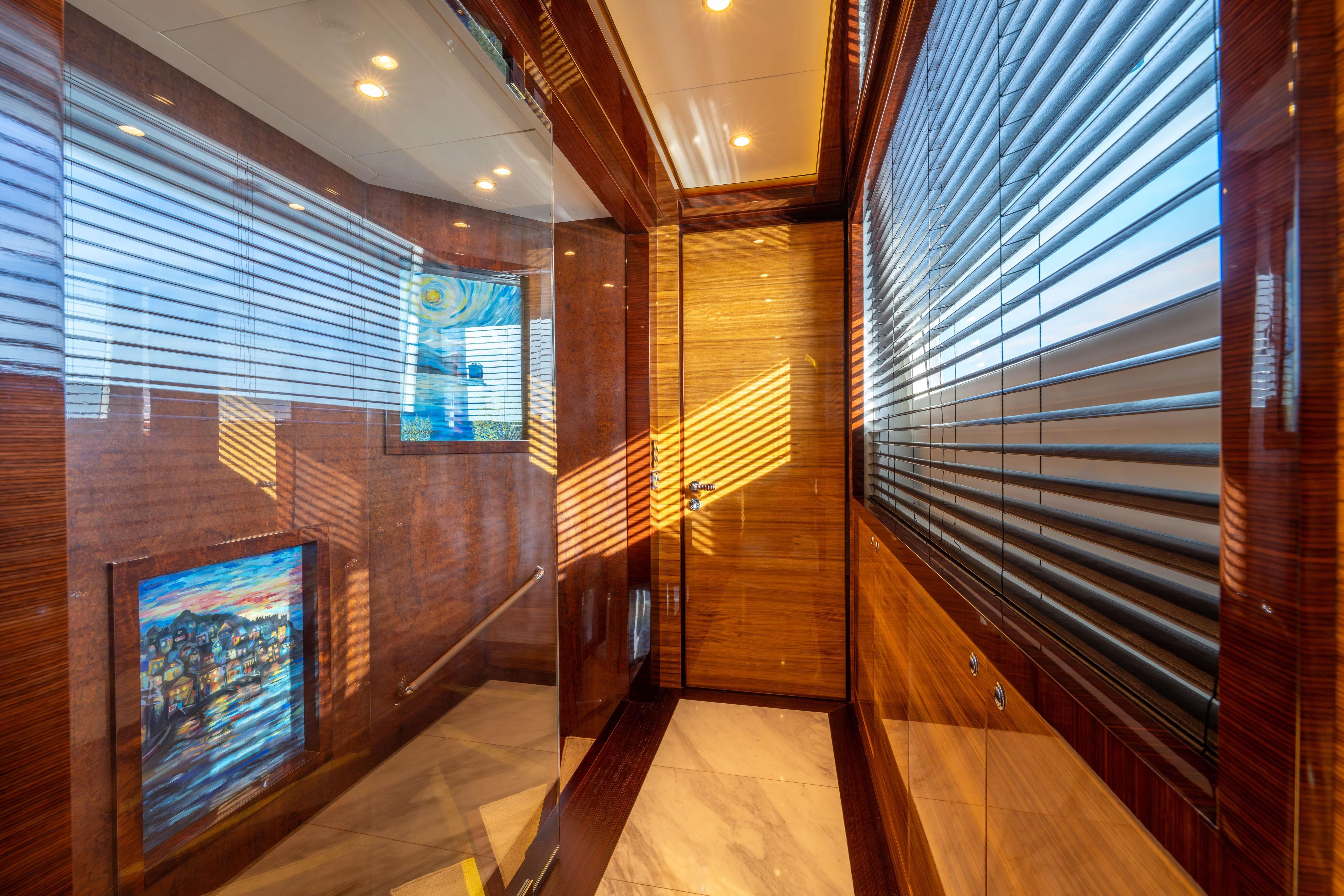 Luxurious Bilgin 147 yacht interior hallway with wood paneling and artwork, 2014 model.