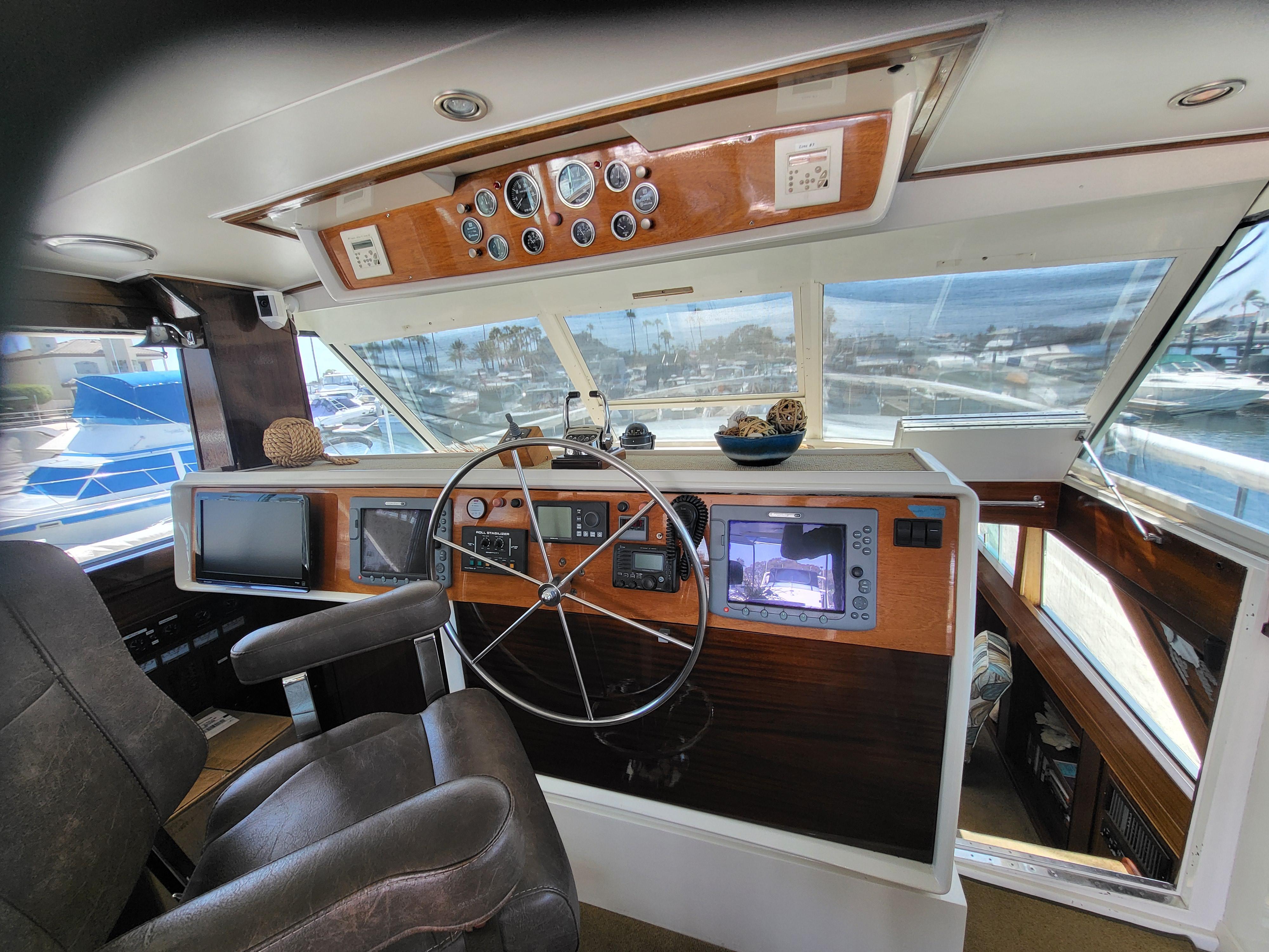 1970 Chris-Craft Commander boat helm with steering wheel, gauges, and navigation equipment.