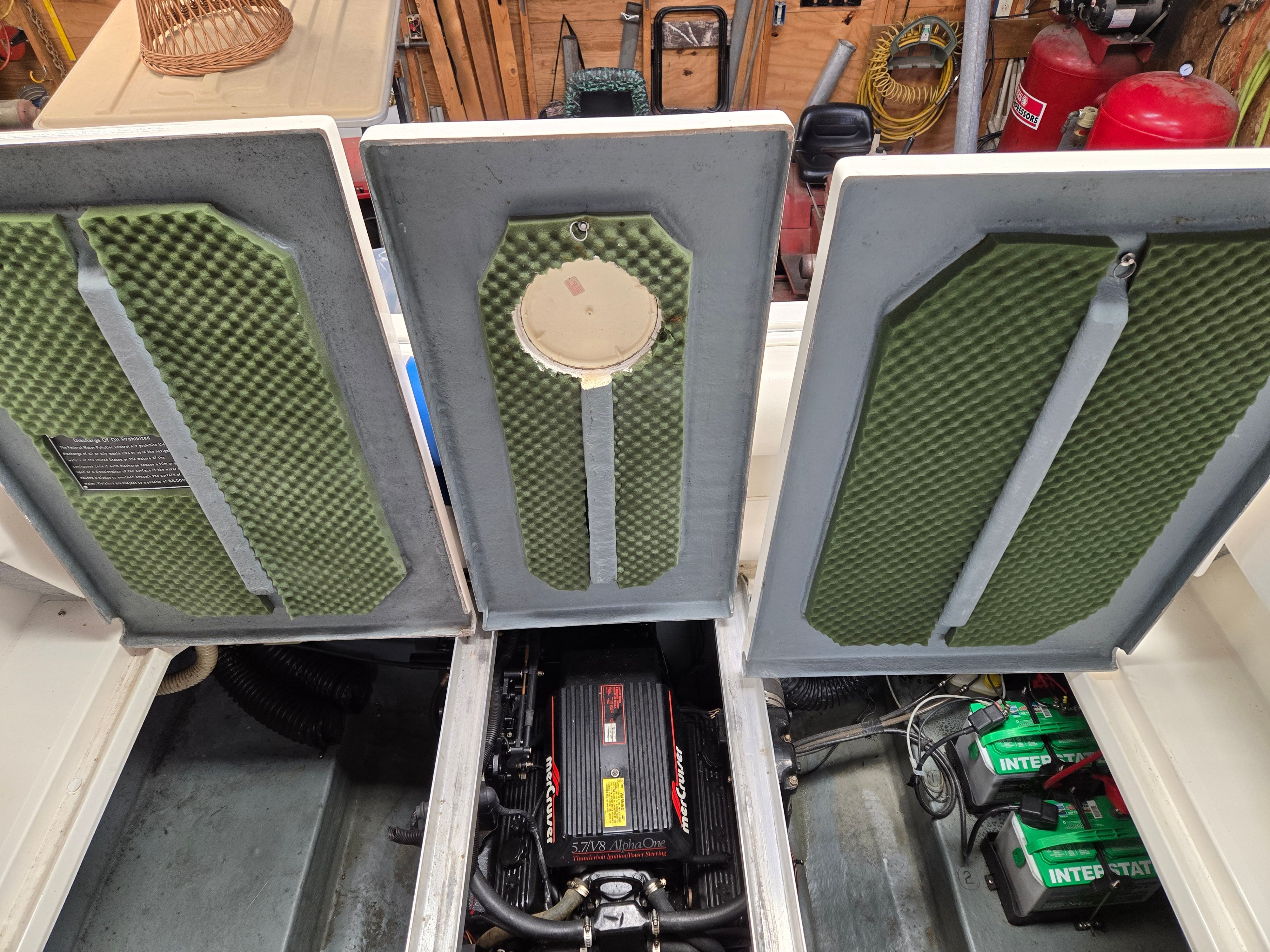 Engine compartment of a 1991 Sea Ray 250 Weekender with open access.