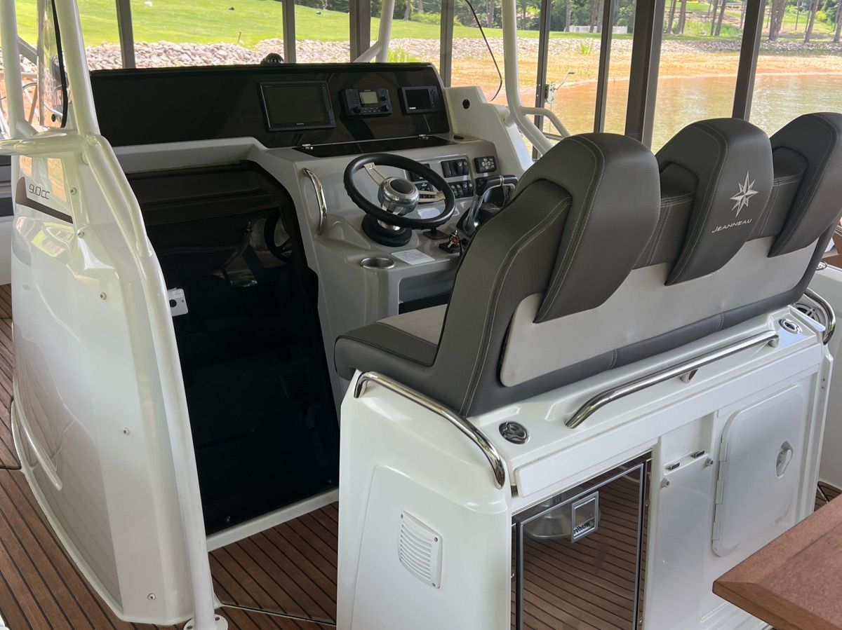 The cockpit of a 2020 Jeanneau Leader 9 with modern instruments and comfortable seating.