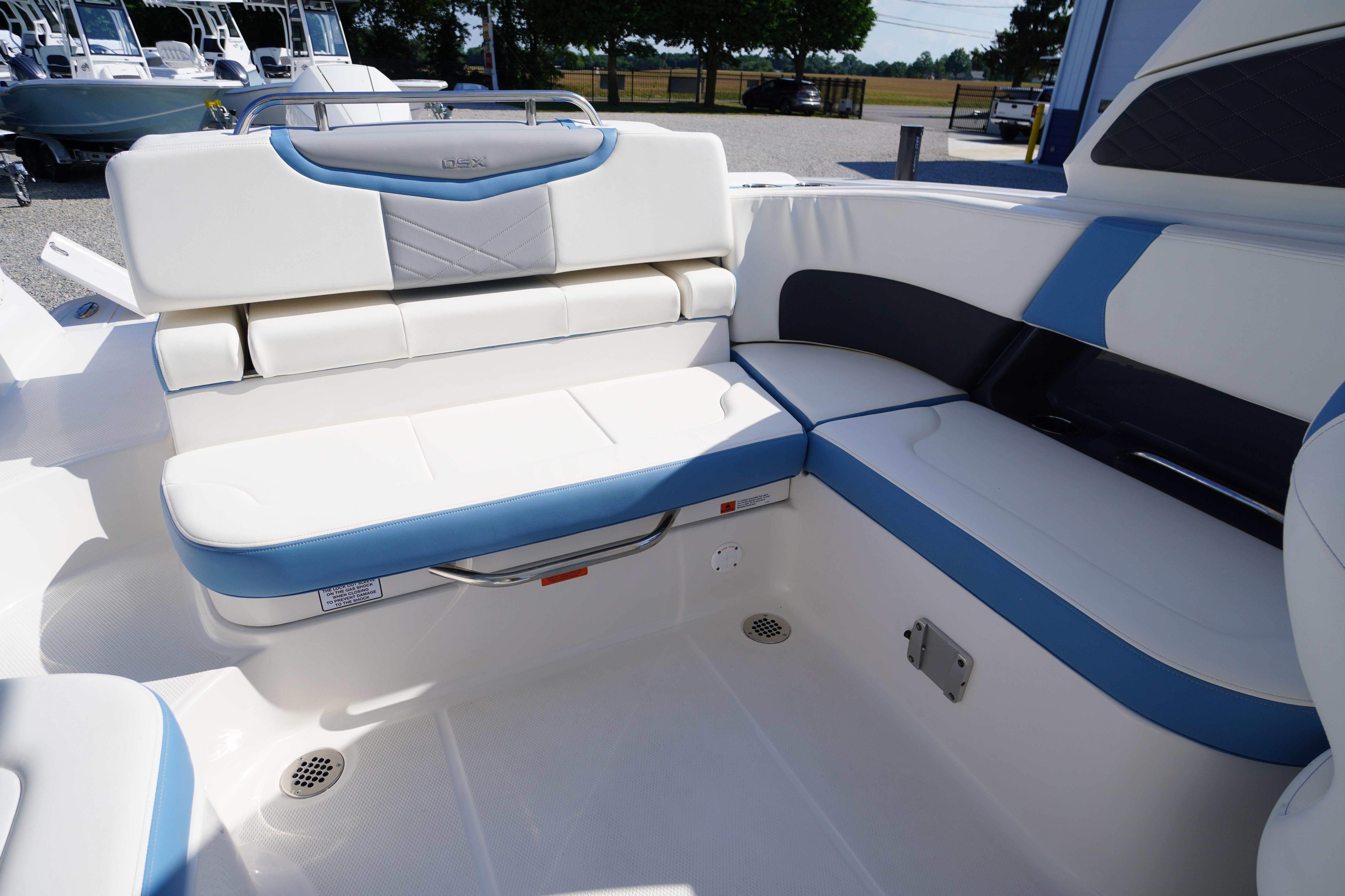 2026 Chaparral 270 OSX boat interior with white and blue seating arrangement.