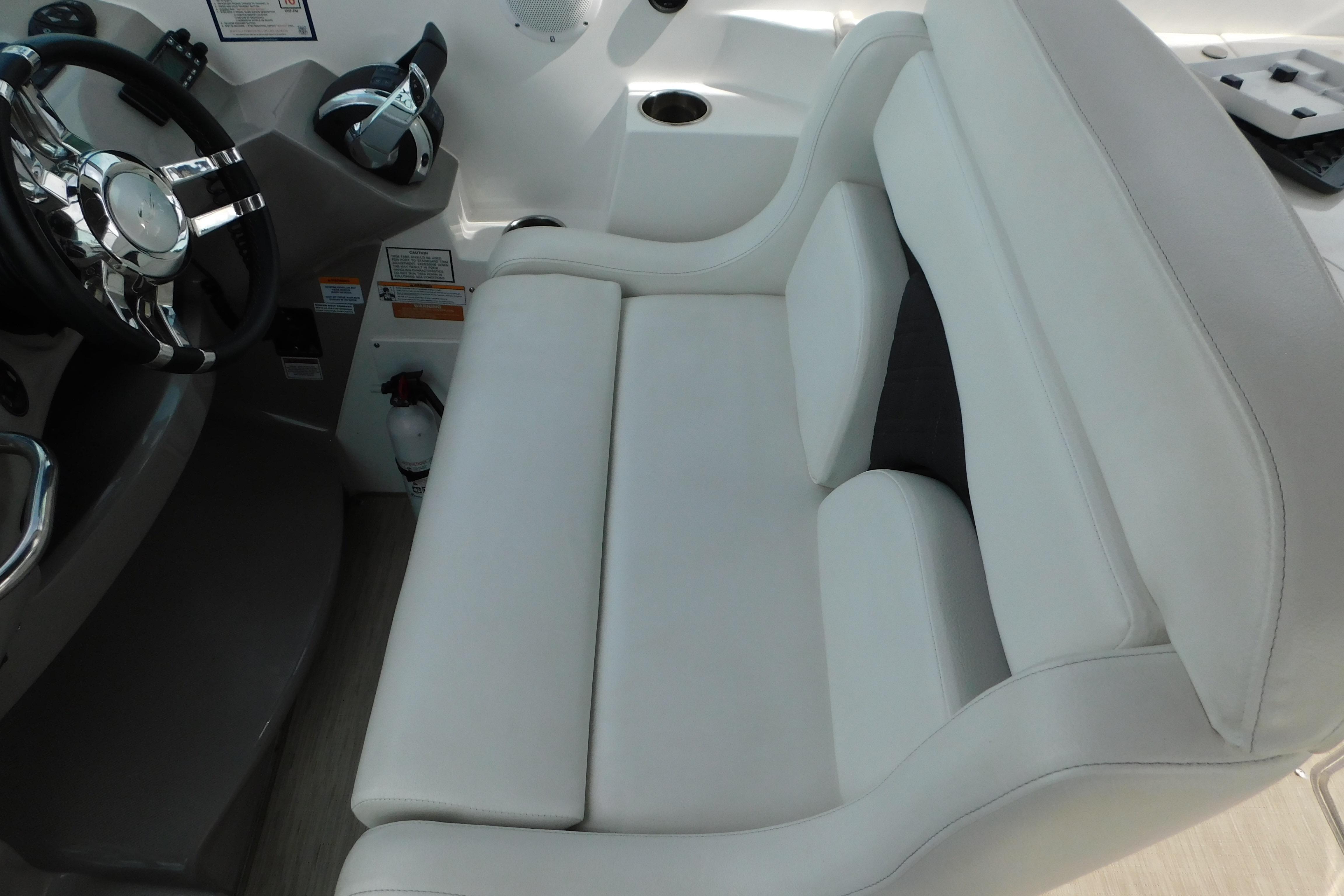 2017 Rinker EX 320 boat interior with white seating and steering wheel.