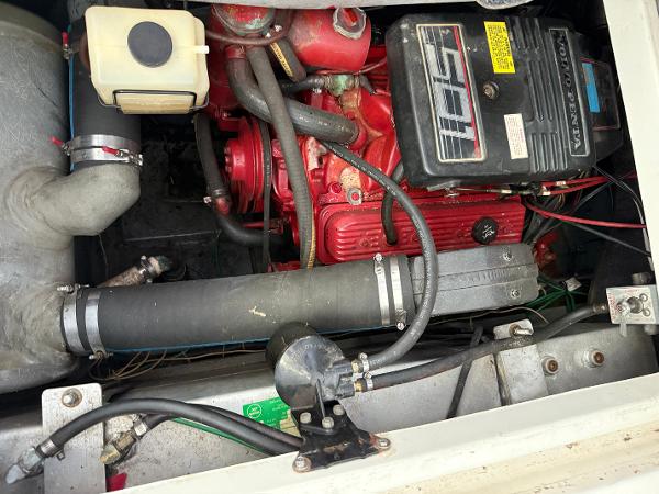 Engine compartment of a 1992 Carver Command Bridge 2828 boat, featuring a red engine.