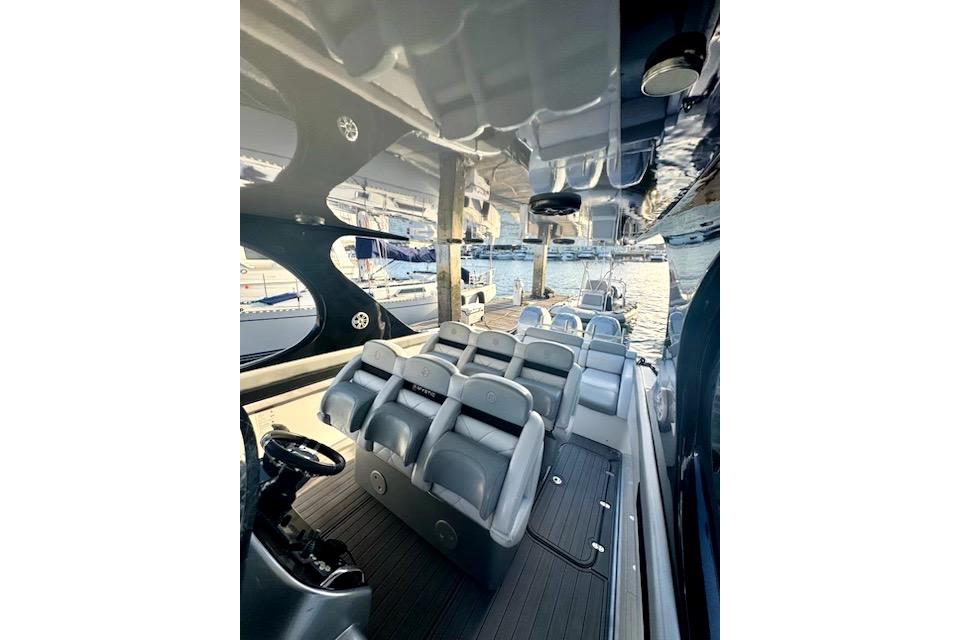 Interior view of a 2016 Mystic M4200 boat with sleek seating and modern design.