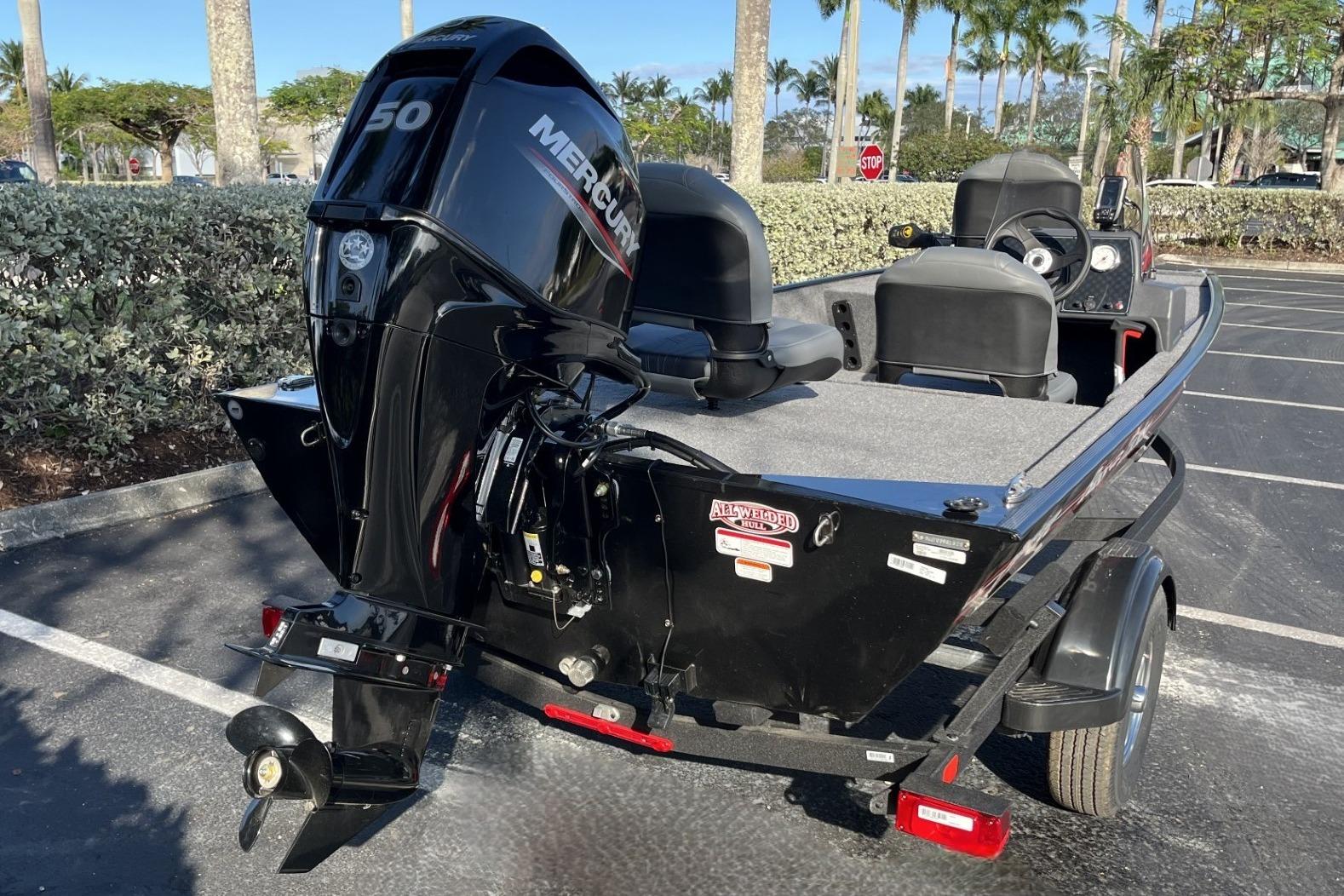 2026 Tracker Bass Tracker Classic XL boat with Mercury engine in parking lot.