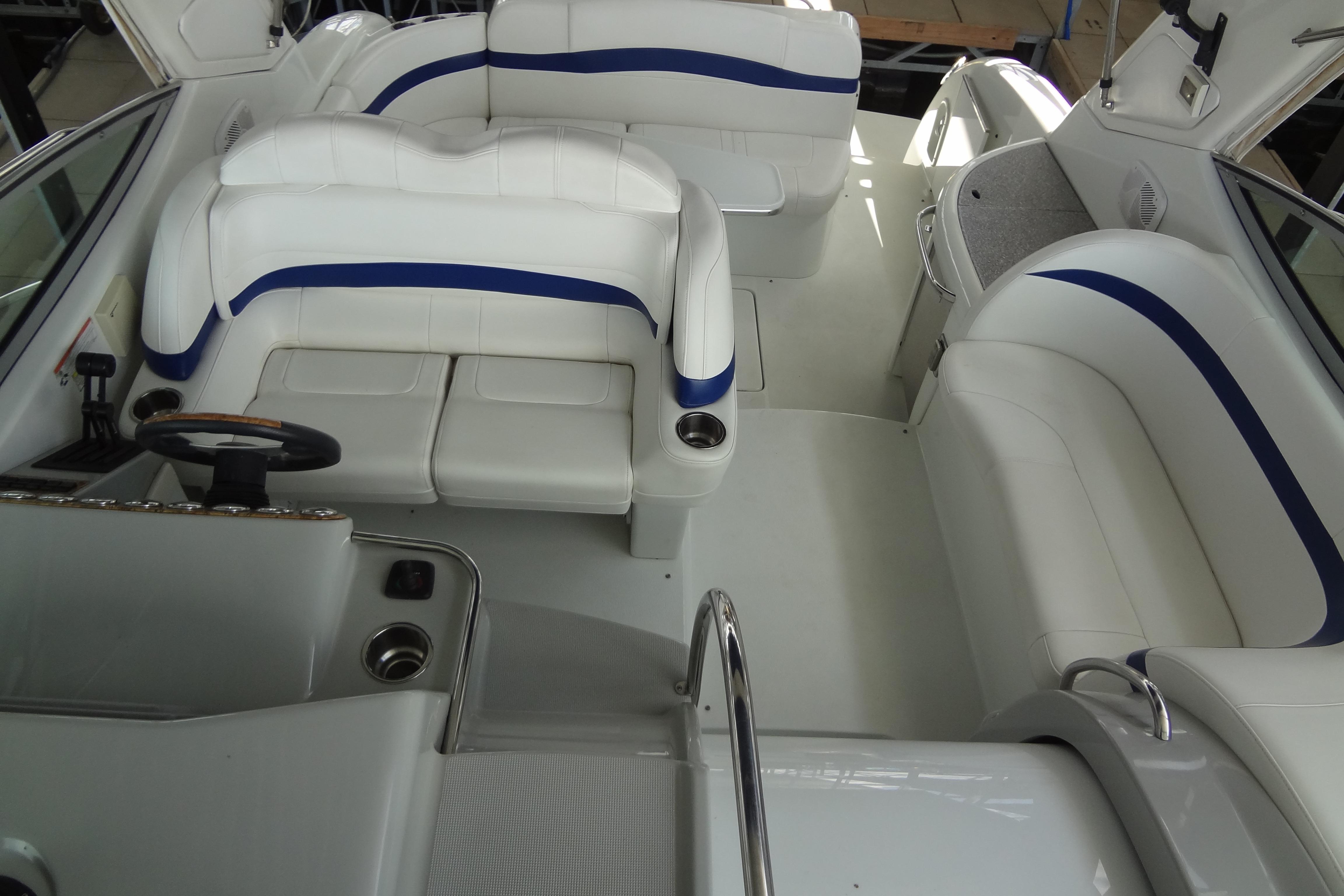 2007 Formula 34 Performance Cruiser interior with white and blue seating, steering wheel, and cup holders.