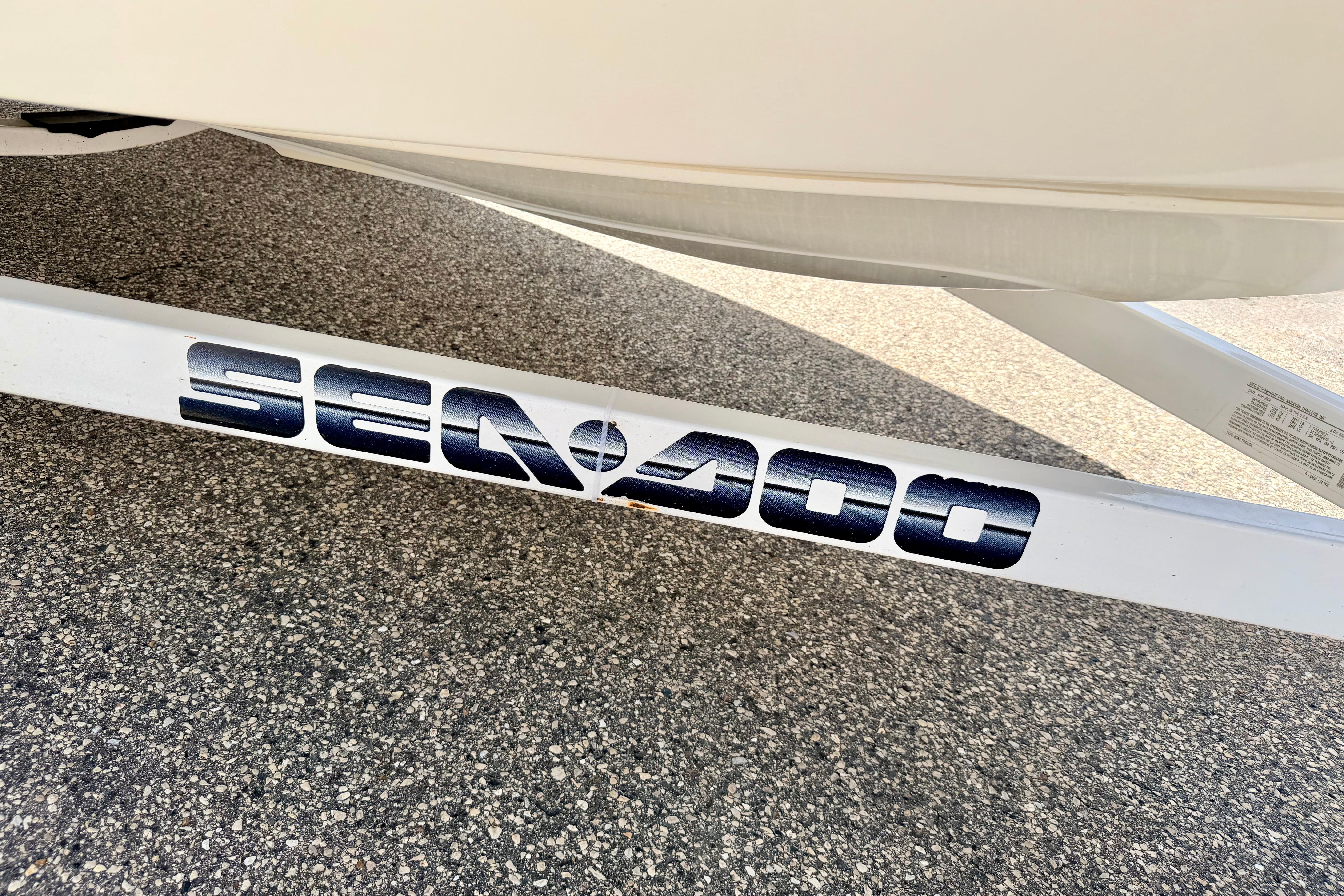 2004 Bombardier SEADOO Utopia 185 trailer on asphalt, featuring bold logo.