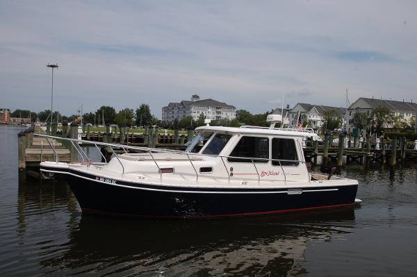 A 2005 Fox Island Thirty Sedan Cruiser is anchored in the water.