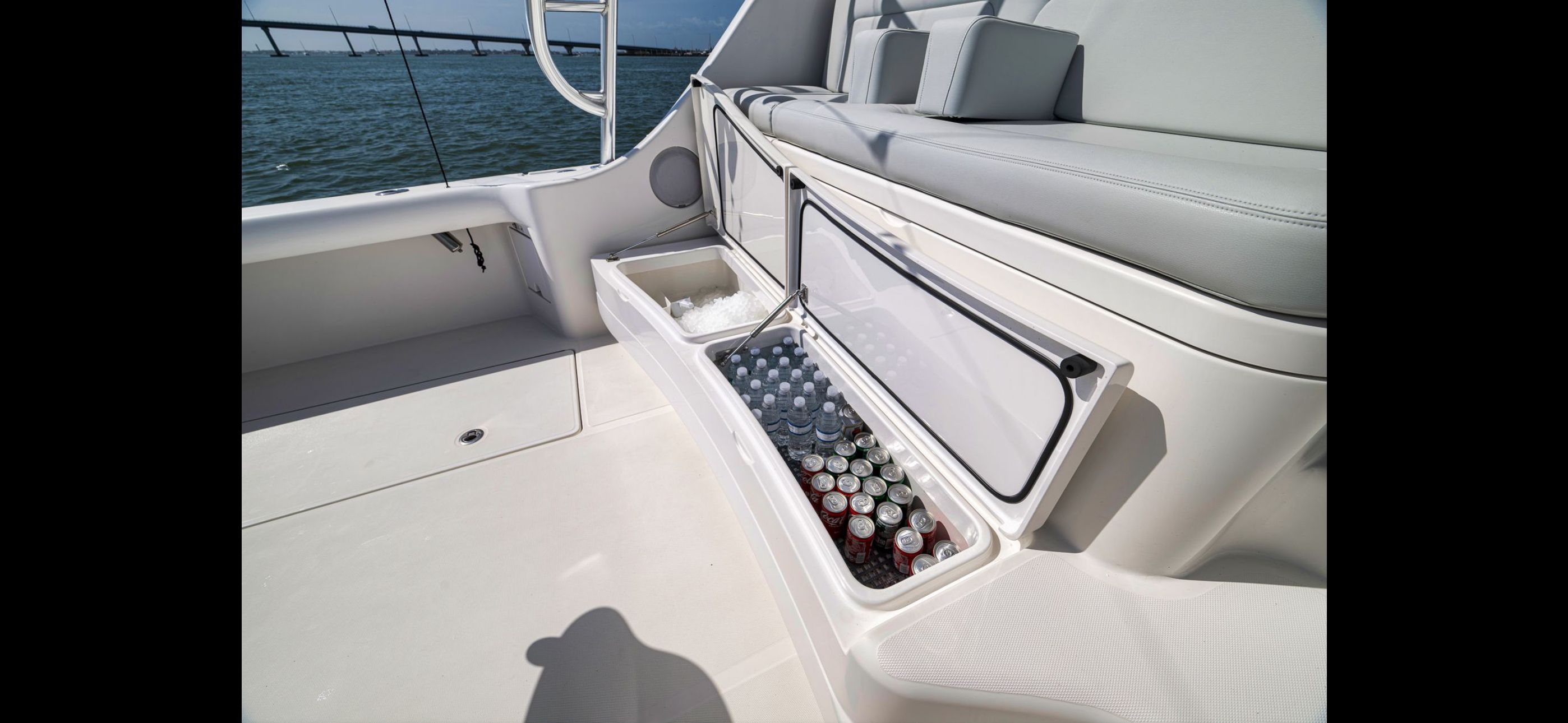 Mag Bay 42 Express 2022 with open cooler compartment on water.