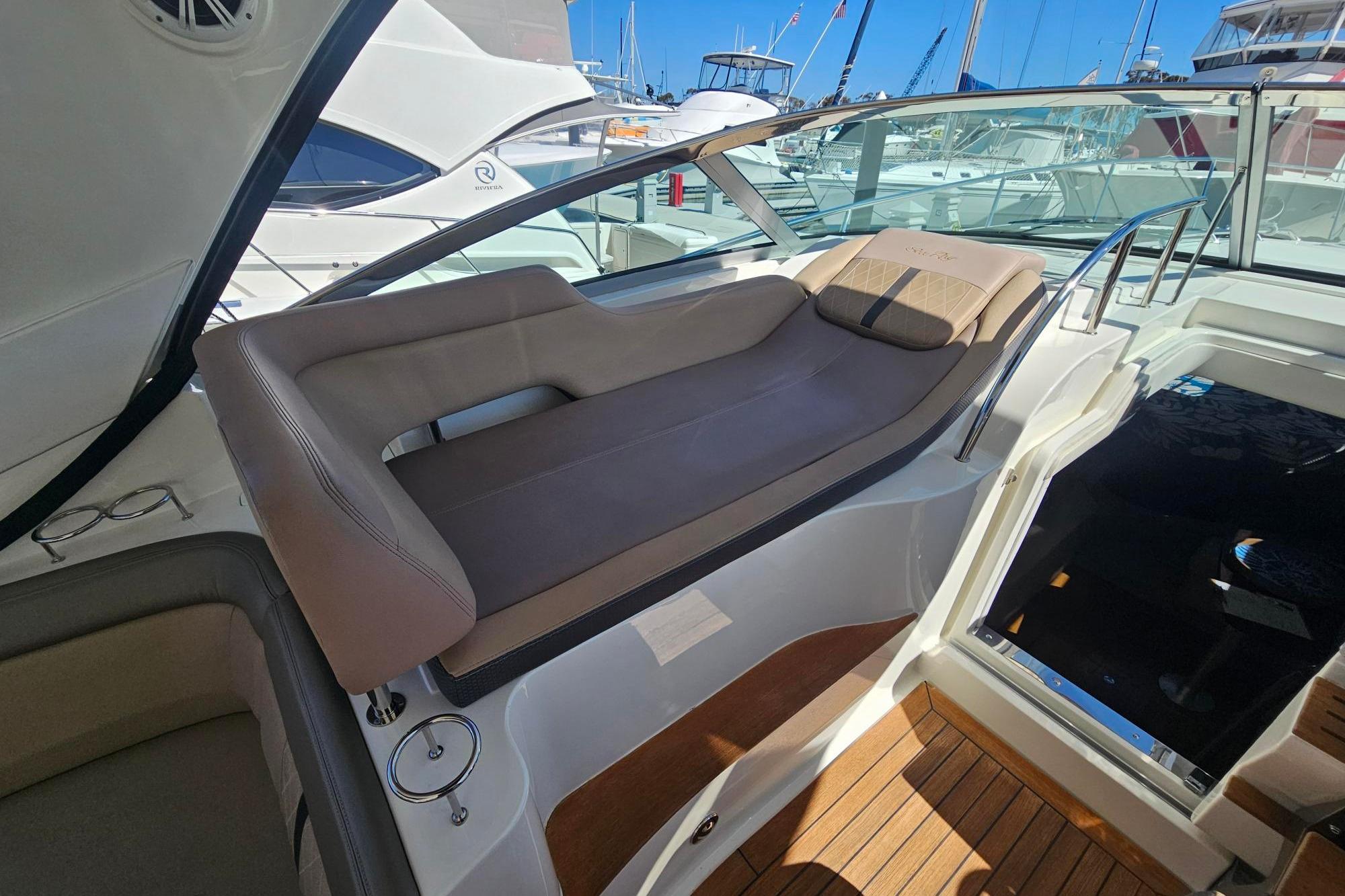 2016 Sea Ray Sundancer 350 interior with luxurious seating and wooden flooring.