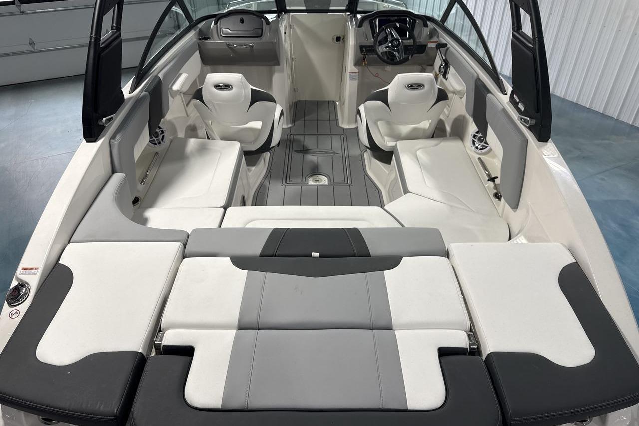 Interior view of a Chaparral 23 SSi boat with gray and white seating.
