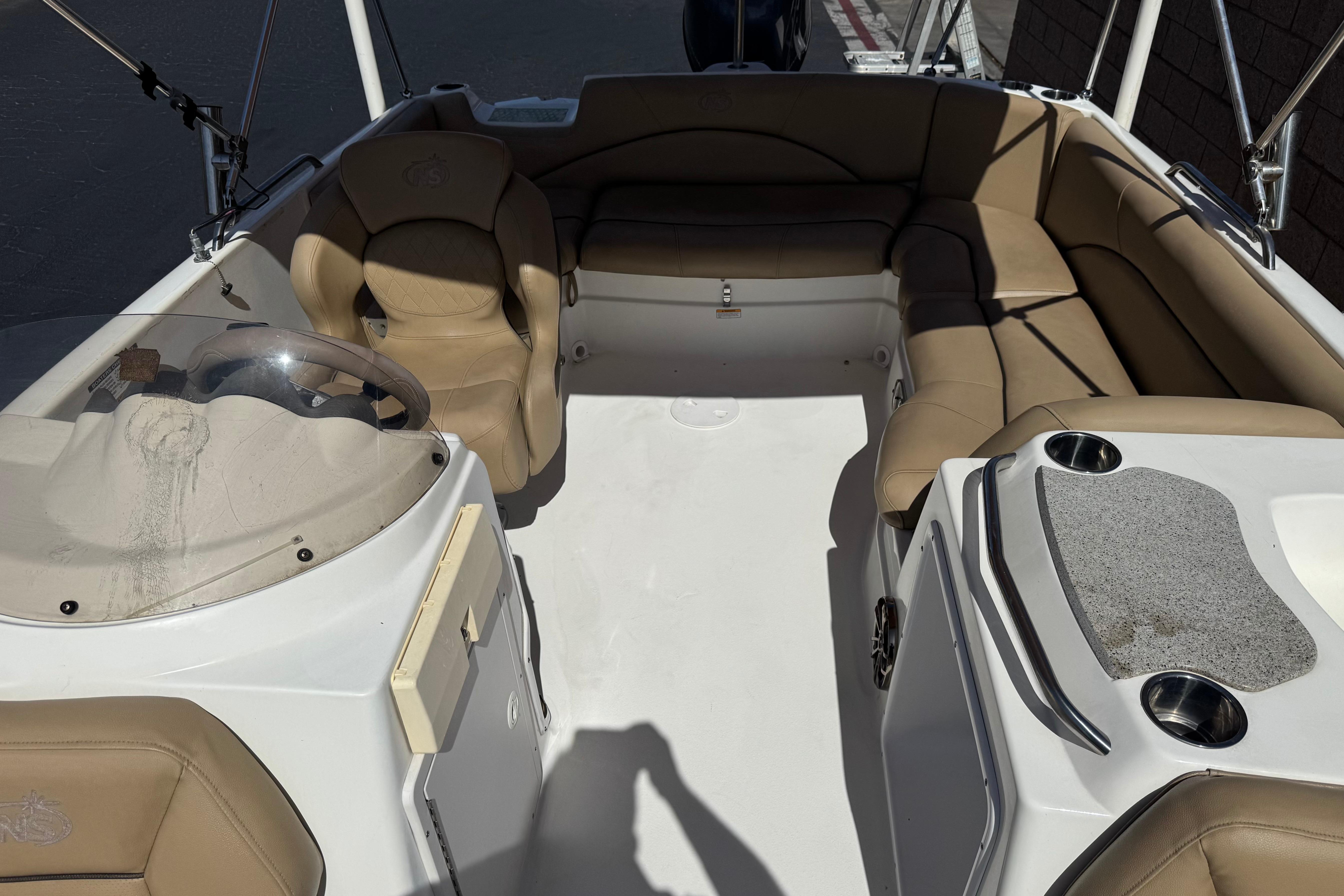 2020 NauticStar 203 SC boat interior with tan seating and steering console.