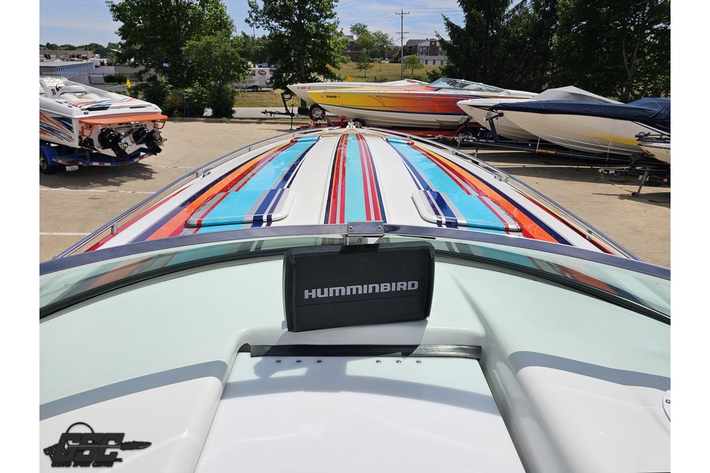 2002 Formula 382 FASTech boat with colorful stripes and Humminbird device on deck.