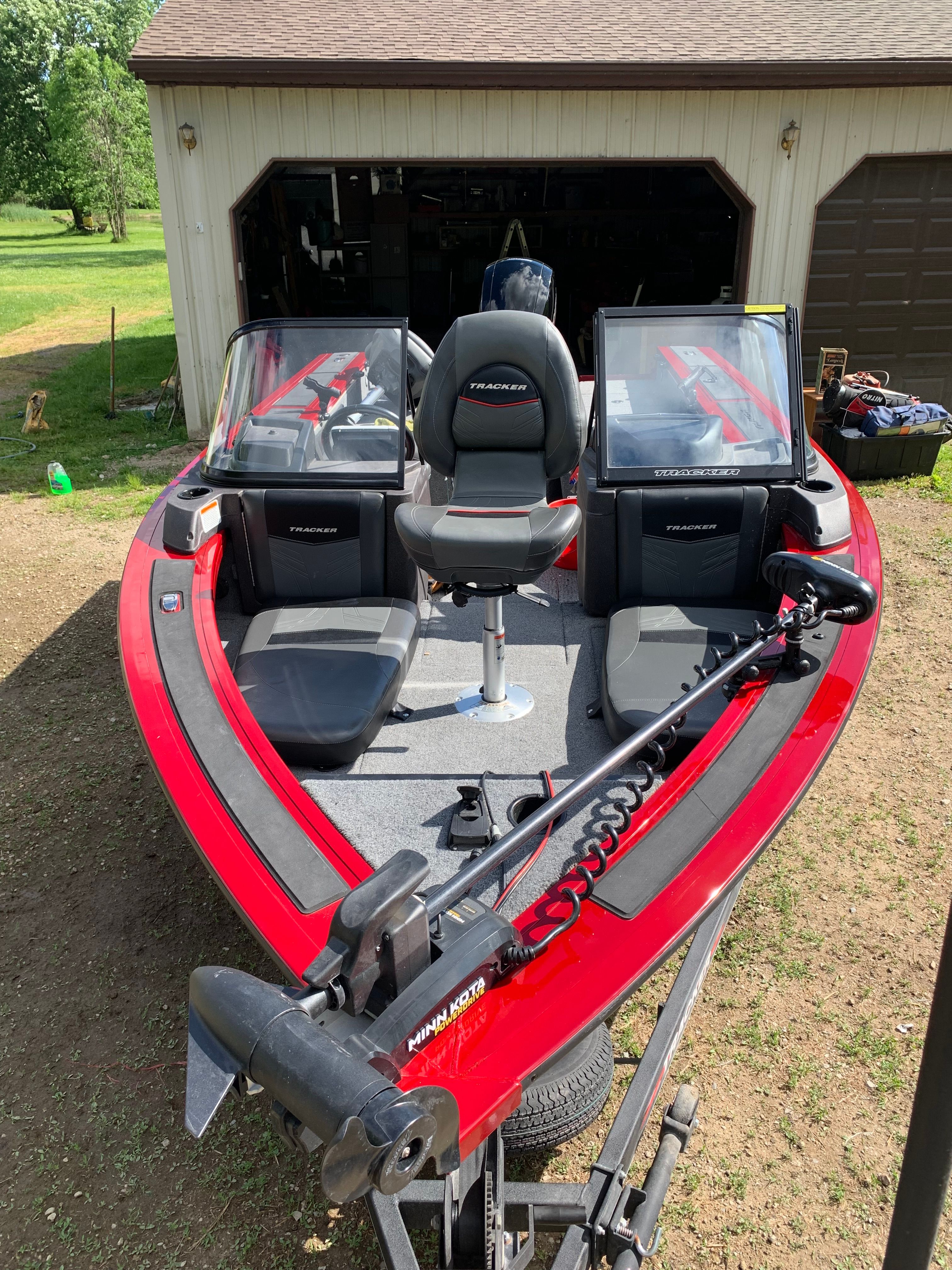 2022 Tracker Targa V-19 WT boat parked in front of garage.