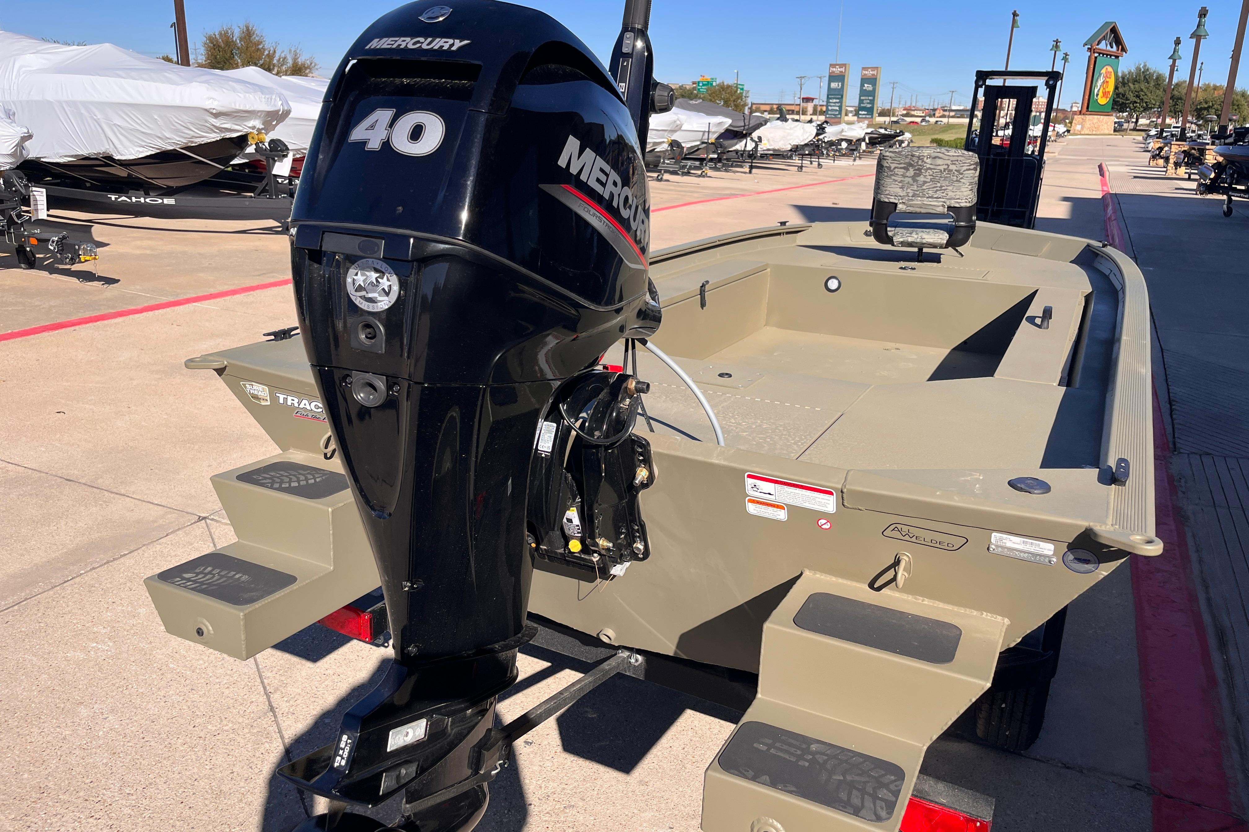 2026 Tracker Grizzly 1654 T Sportsman boat with Mercury 40 engine, displayed outdoors.