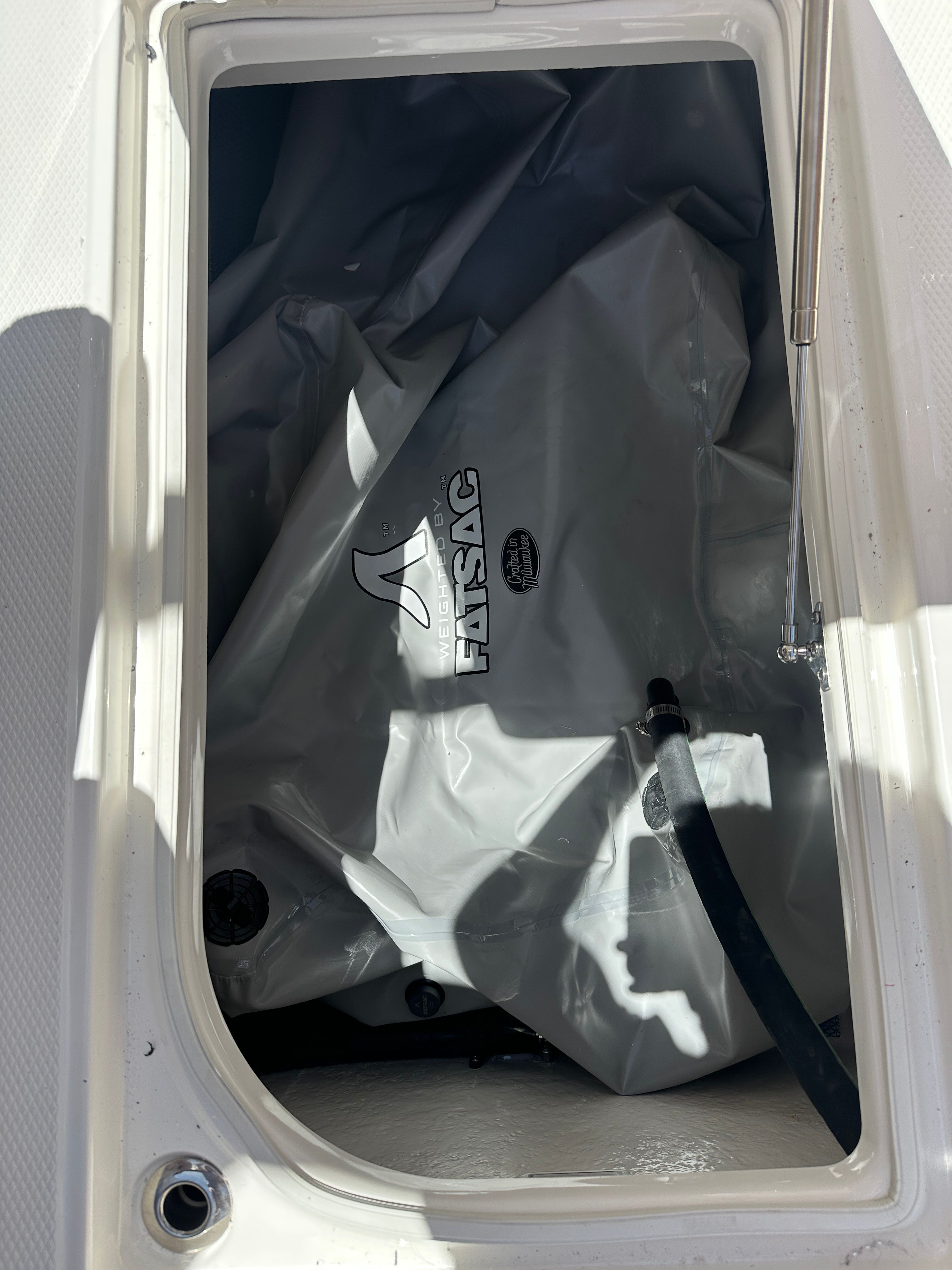 A Fatsac ballast bag in a storage compartment of a Chaparral 26 Surf boat.
