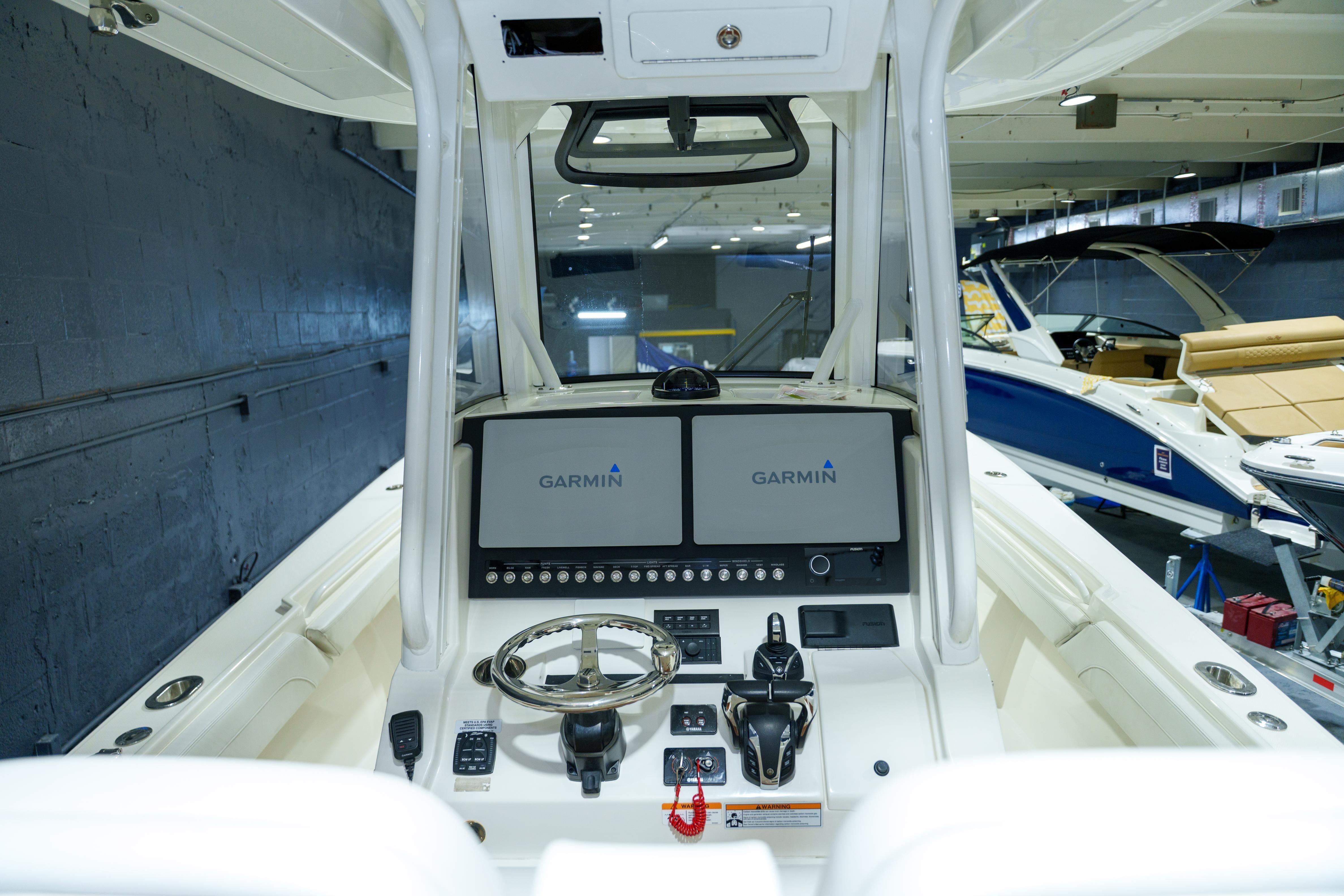 2023 Regulator 28 boat dashboard with Garmin navigation system in showroom.