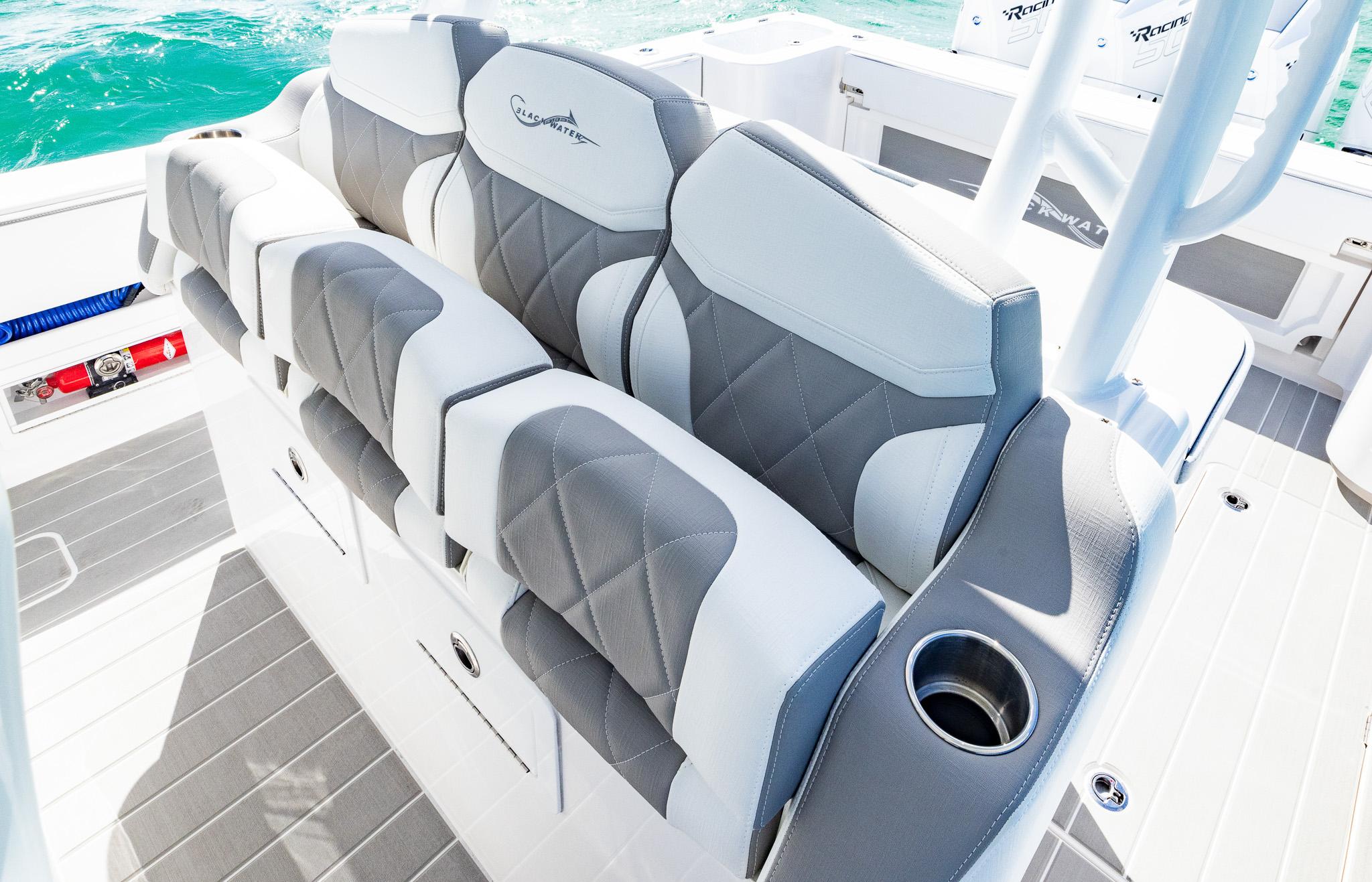 Luxurious seating on 2025 Blackwater 43 Sportfish boat with cup holder, gray and white design.