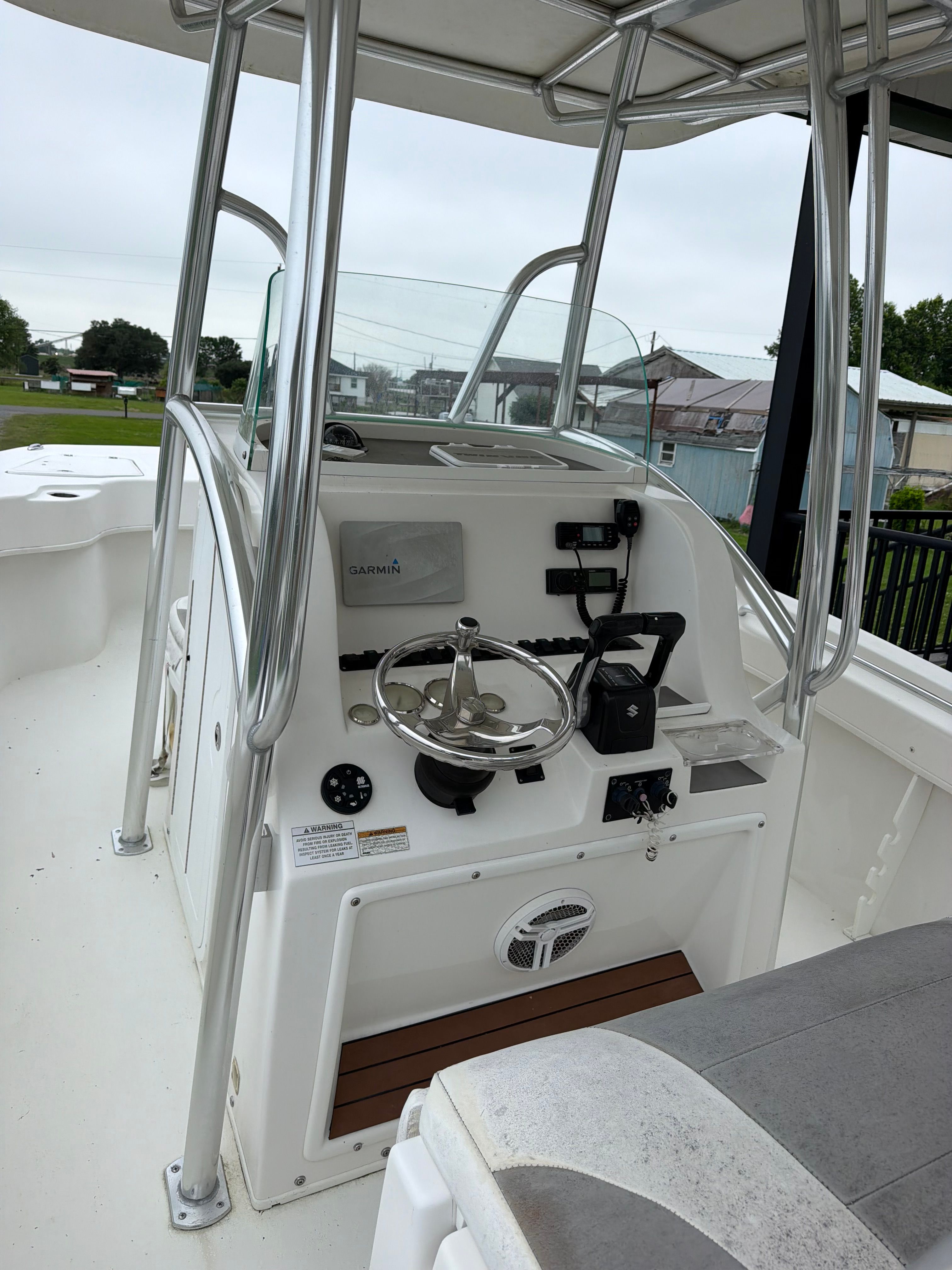 The helm of a Twin Vee Ocean Cat boat with steering wheel and instruments.